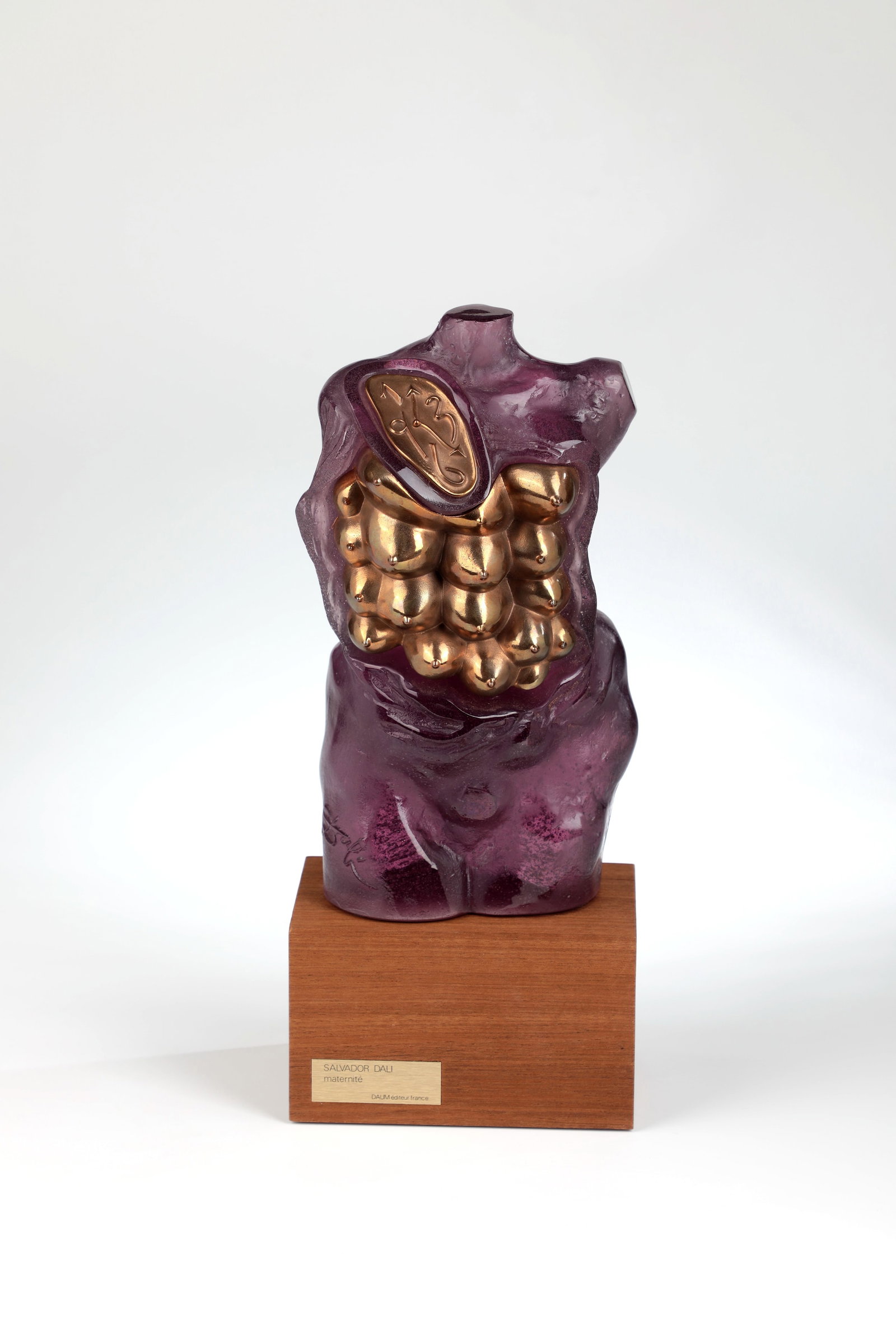 ''Maternité'': ''Maternité'' Salvador Dali (design), Cristallerie Daum, 1978 Pâte de verre in colourless and violet, moulded. Bronze mount. Inscribed: Dali (raised molten), DAUM FRANCE, 175/200 (engraved). With wo