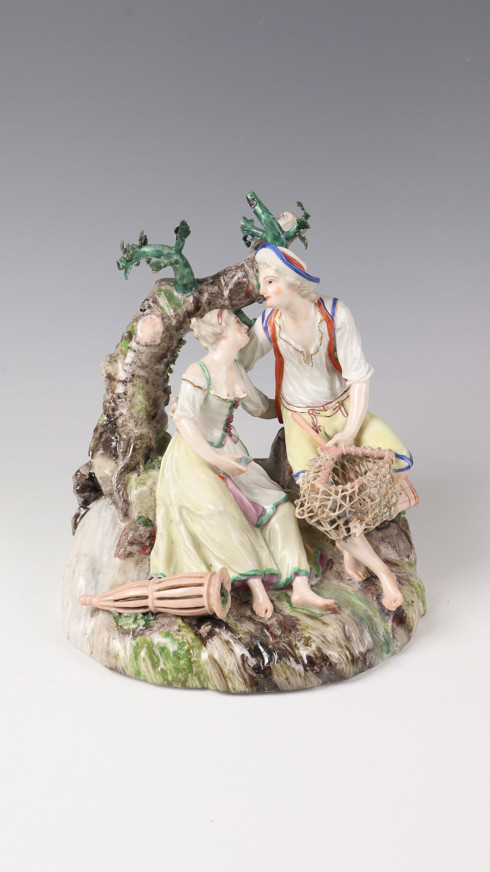 Fishing group: Ludwigsburg Fishermen's Group around 1765 Porcelain, glazed, polychrome painted. A fisherman sits on a natural pedestal with a tree trunk, embracing his wife. In his hand a landing net with fish, she 
