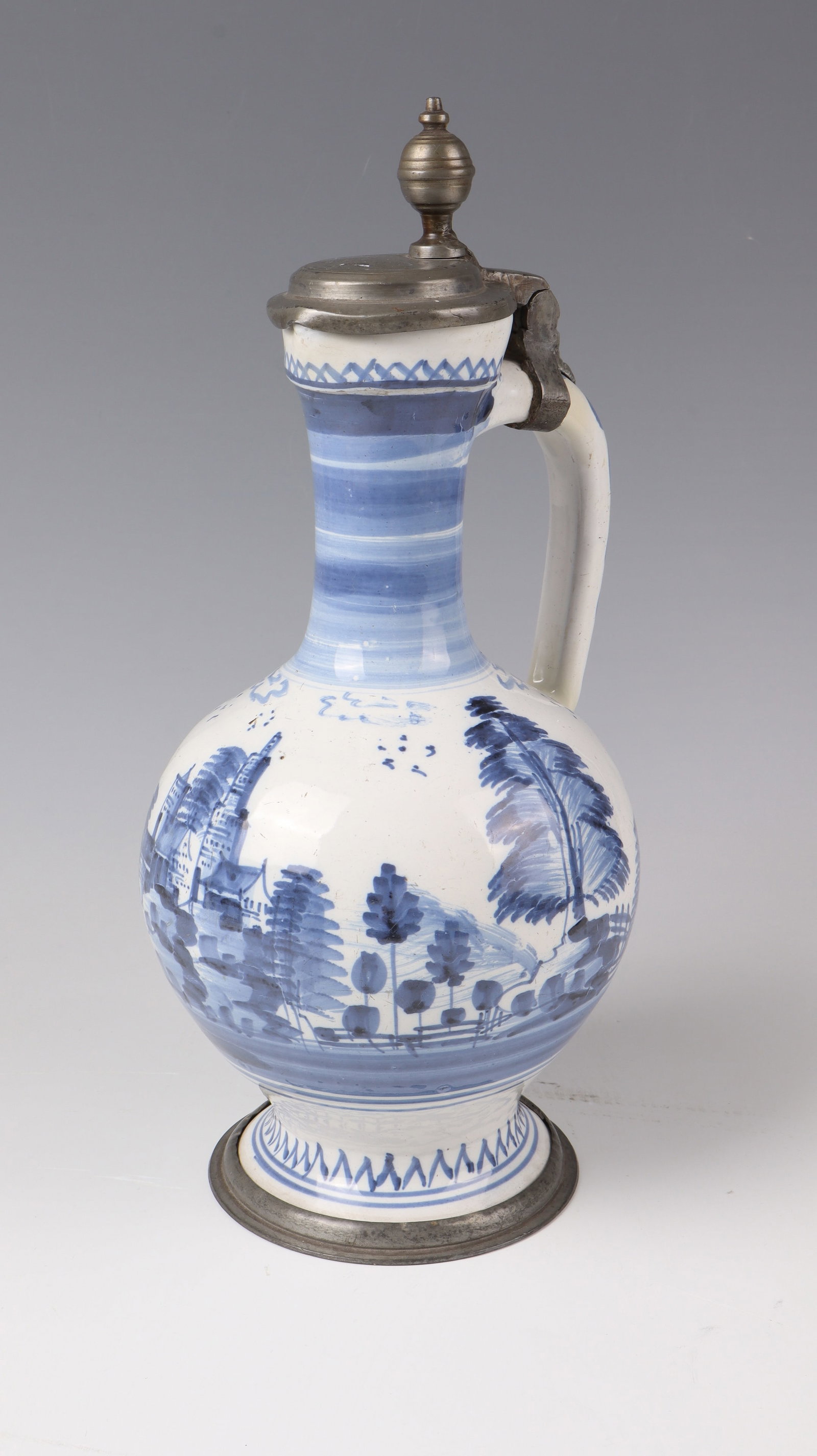 Large Narrow-Neck Pitcher with Pewter Mount: Large narrow-necked jug with pewter mount Ansbach or Nuremberg, around 1730 Exhibited stand set by pewter frost. On the spherical wall painted in shades of blue all around with a rocky landscape with 
