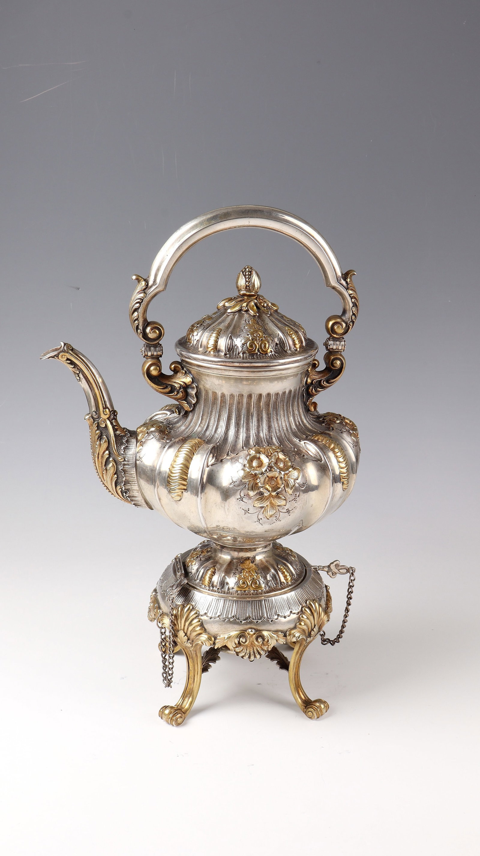 Important tea kettle: Important tea kettle Wohl Werkstatt Paul Telge, Berlin, c. 1894 silver, partly gilded. Base articulated on four curved feet with rolled up bases with cast and embossed shellwork. Above it is a wreath 