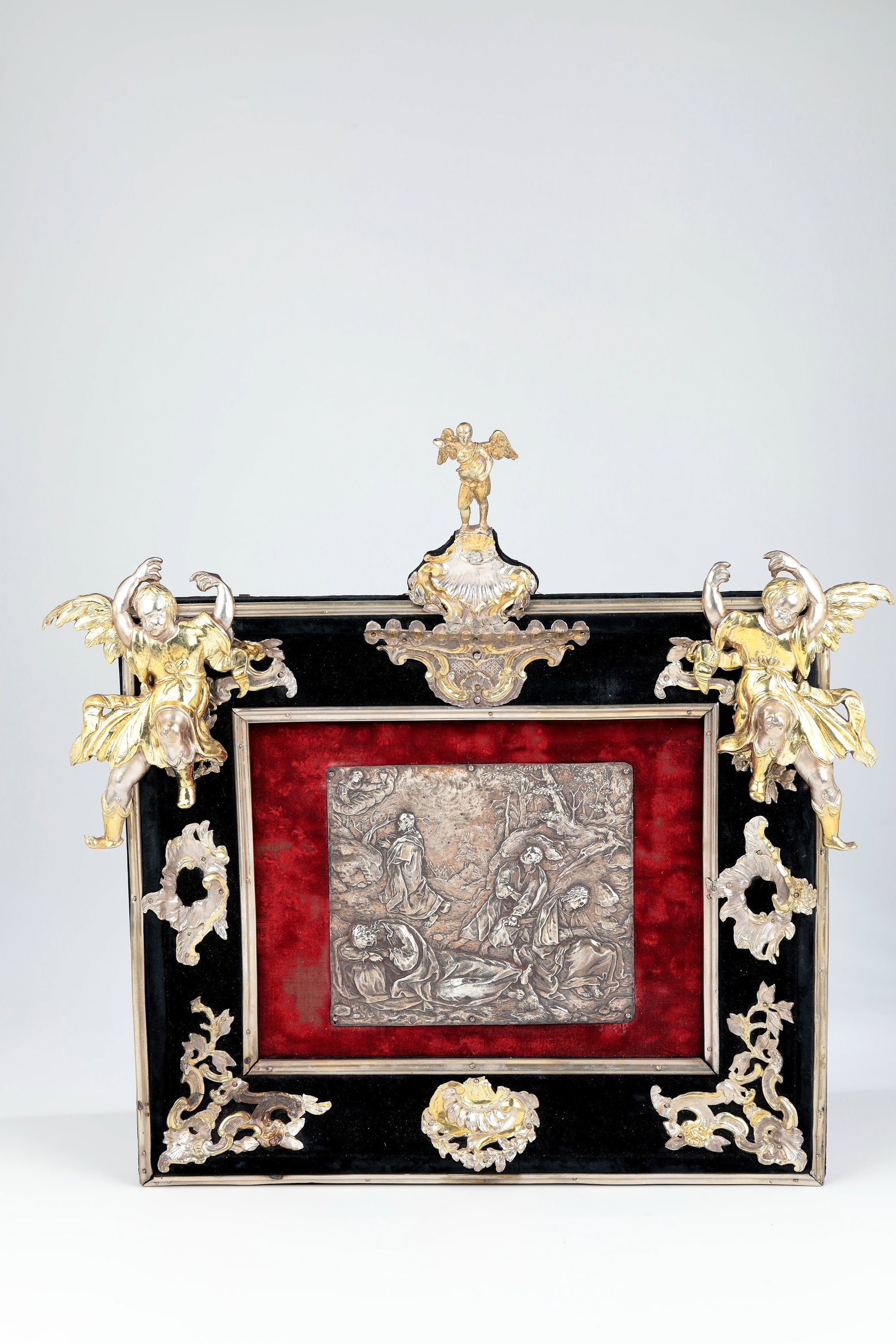 Relief plaque with Gethsemane scene in rococo frame: Relief plaque with Gethsemane scene in Rococo frame Southern Germany or Austria, last third of the 18th century Embossed silver plaque set on red velvet with the depiction of Jesus and the three disci