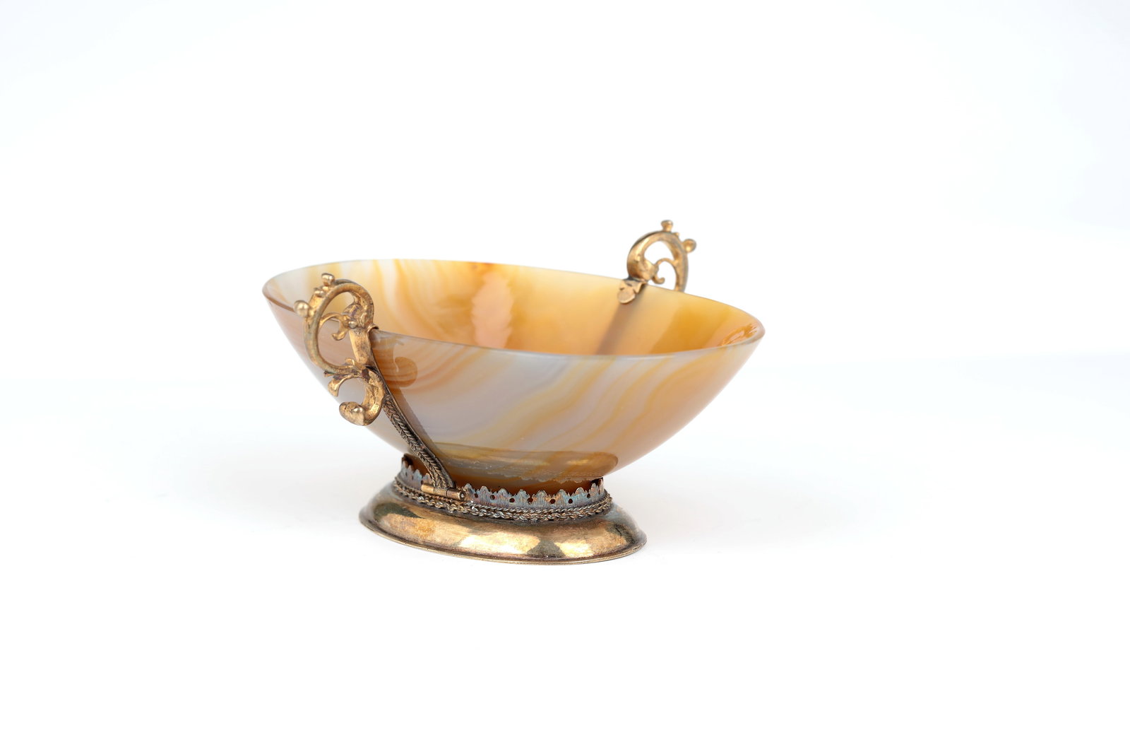Agate bowl with silver mount: Agate bowl with silver mount Probably German, 17th century Oval hollow base with slightly flared base. Silver-gilt setting with acanthus leaf frieze. Two ear handles on the sides. L. 10.5 cm.