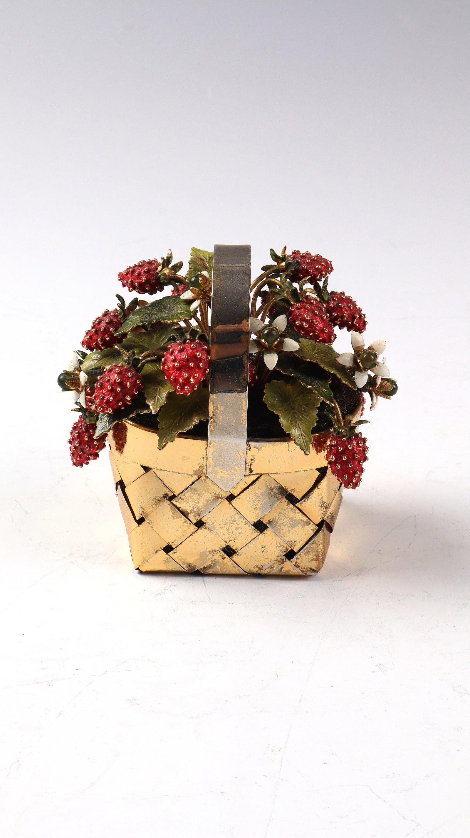Basket with strawberries: Basket with Strawberries Cartier, USA circa 1950 Rectangular wicker basket made of gilded 925 sterling silver, filled with enameled strawberries, flowers with green glass cabochons and leaves.