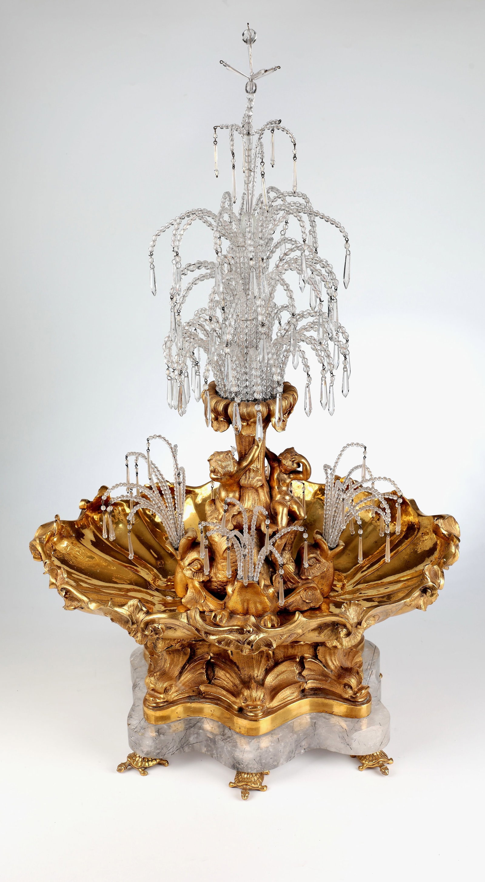 Monumental Fountain: Monumental fountain France or Germany, 18th/19th century. Base, bowl and the fountain made of gilded bronze, top made of rock crystal, the water drops made of glass. A rock crystal slab resting on six