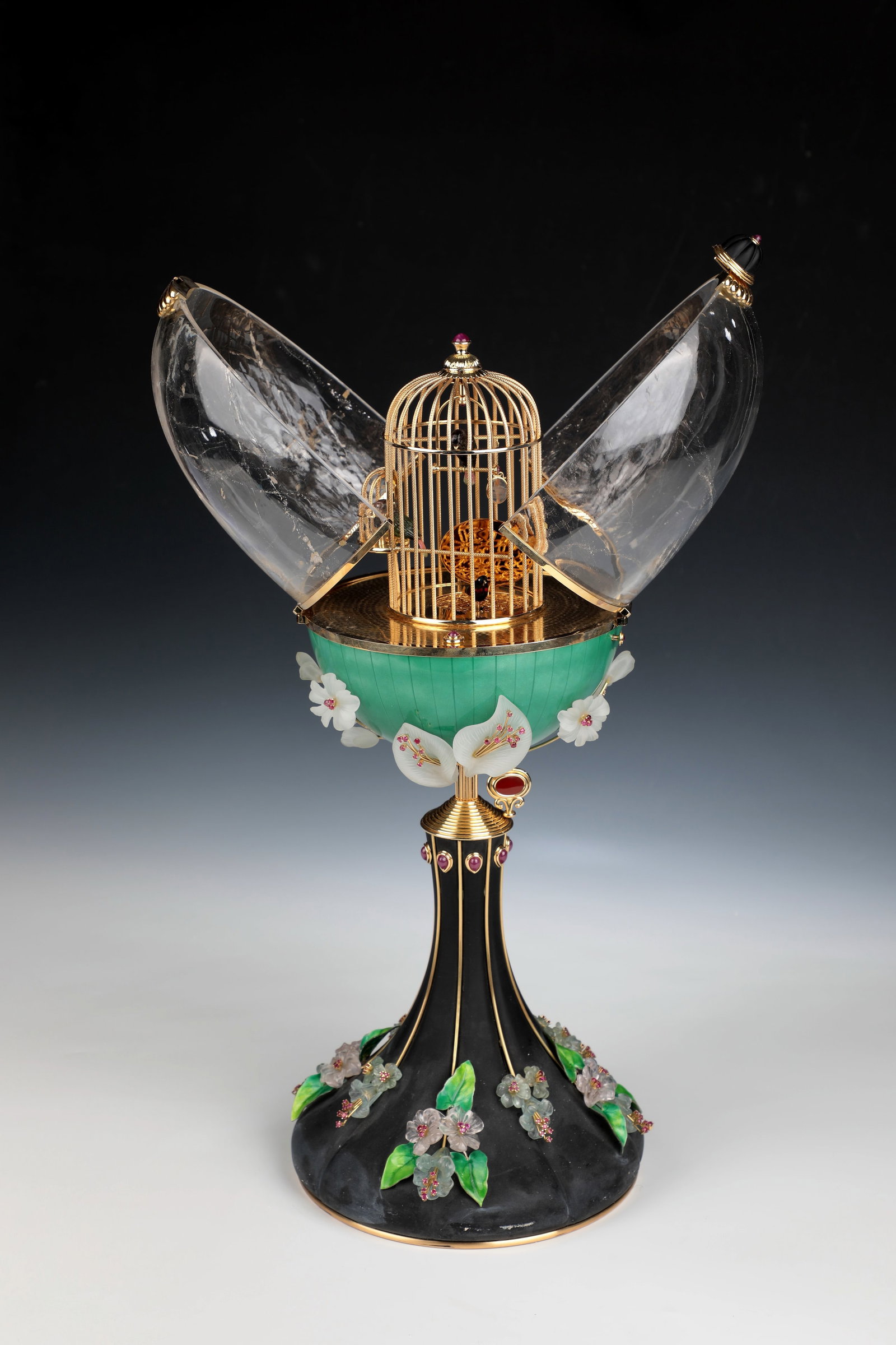 Songbird egg: Important songbird egg Artfully designed egg creation made of 915 grams of 18K gold and 142ct. Aquamarine, 138ct. Morganite, 53ct. Tourmaline, 14.2ct. faceted rubies and 16.56ct. Ruby cabochons. On a 