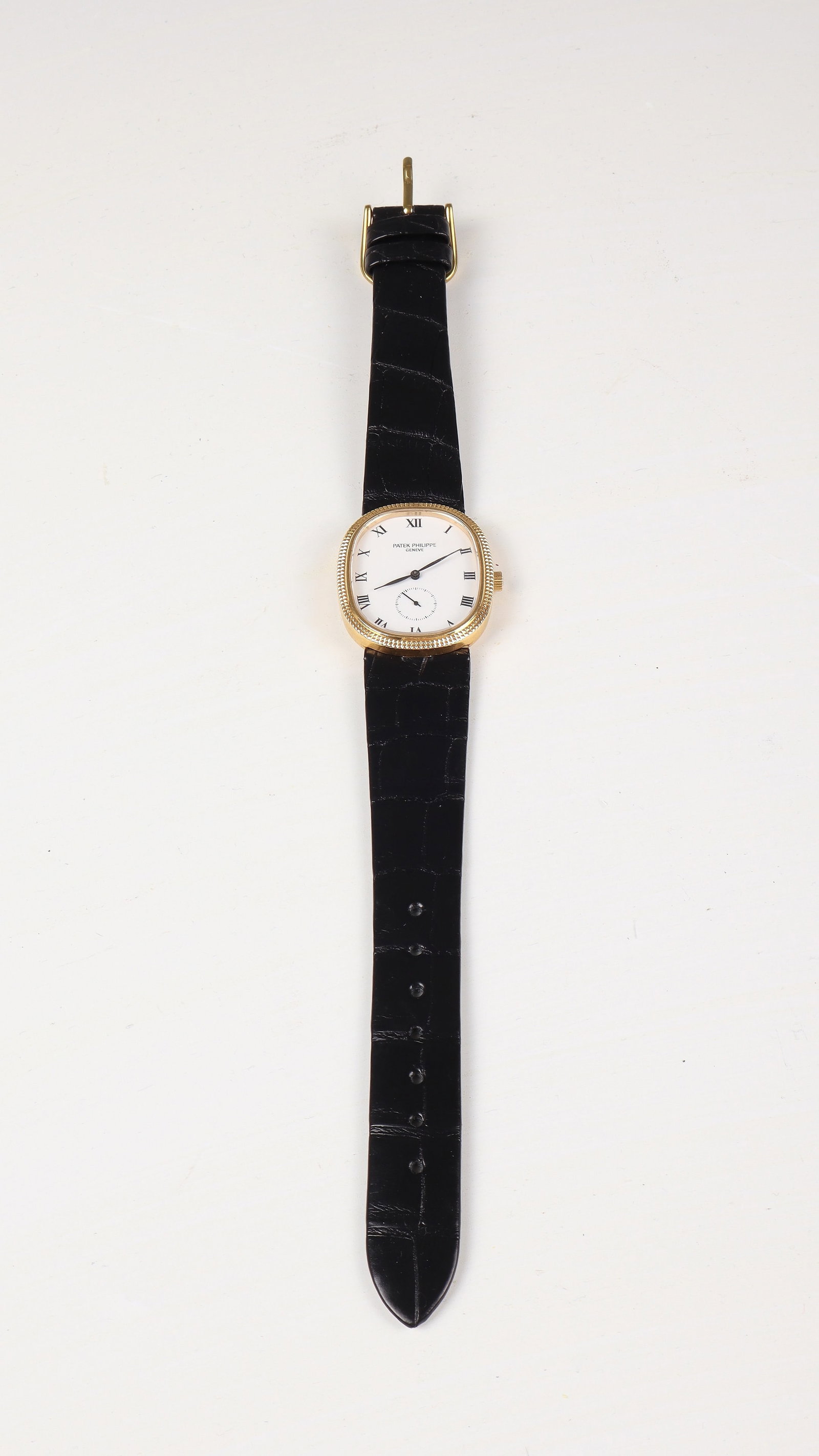 Wristwatch: Patek Philippe Golden Ellipse Wristwatch, Ref. 3987 Ultra-fine oval 18 kt. GG Gold case with hammered bezel. White dial with black Roman numerals, black lance hands and small, off-centre seconds at th