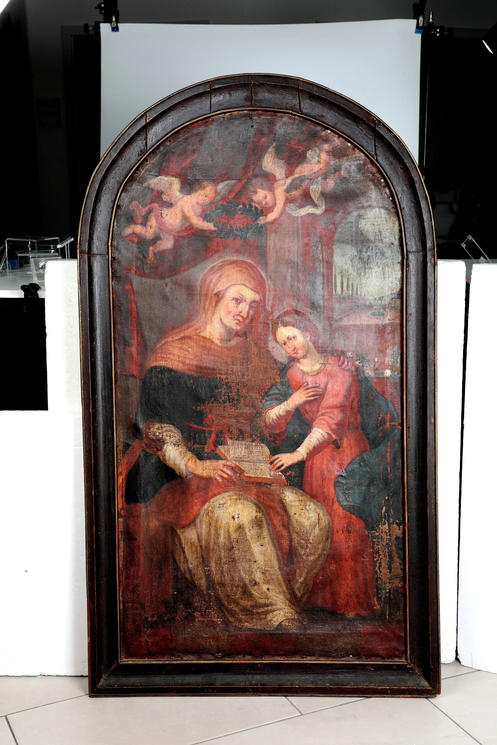 Italian School: Italian School Italy, probably 16th-17th century Saint Anne teaches her daughter Mara to read. Depiction of St. Anne teaching her daughter Mary to read. In the upper part of the picture, two winged