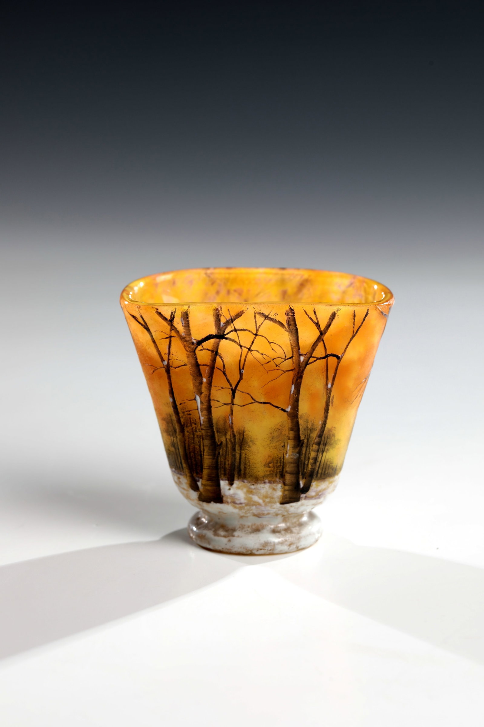 Small vase ''Paysage d'hiver'': Small vase ''Paysage d'hiver'' Daum Fréres, Nancy, c. 1902 Colorless glass, orange and lemon yellow powder inclusions. Flat relief etched, colourfully enamelled décor: wintry tree landscape 