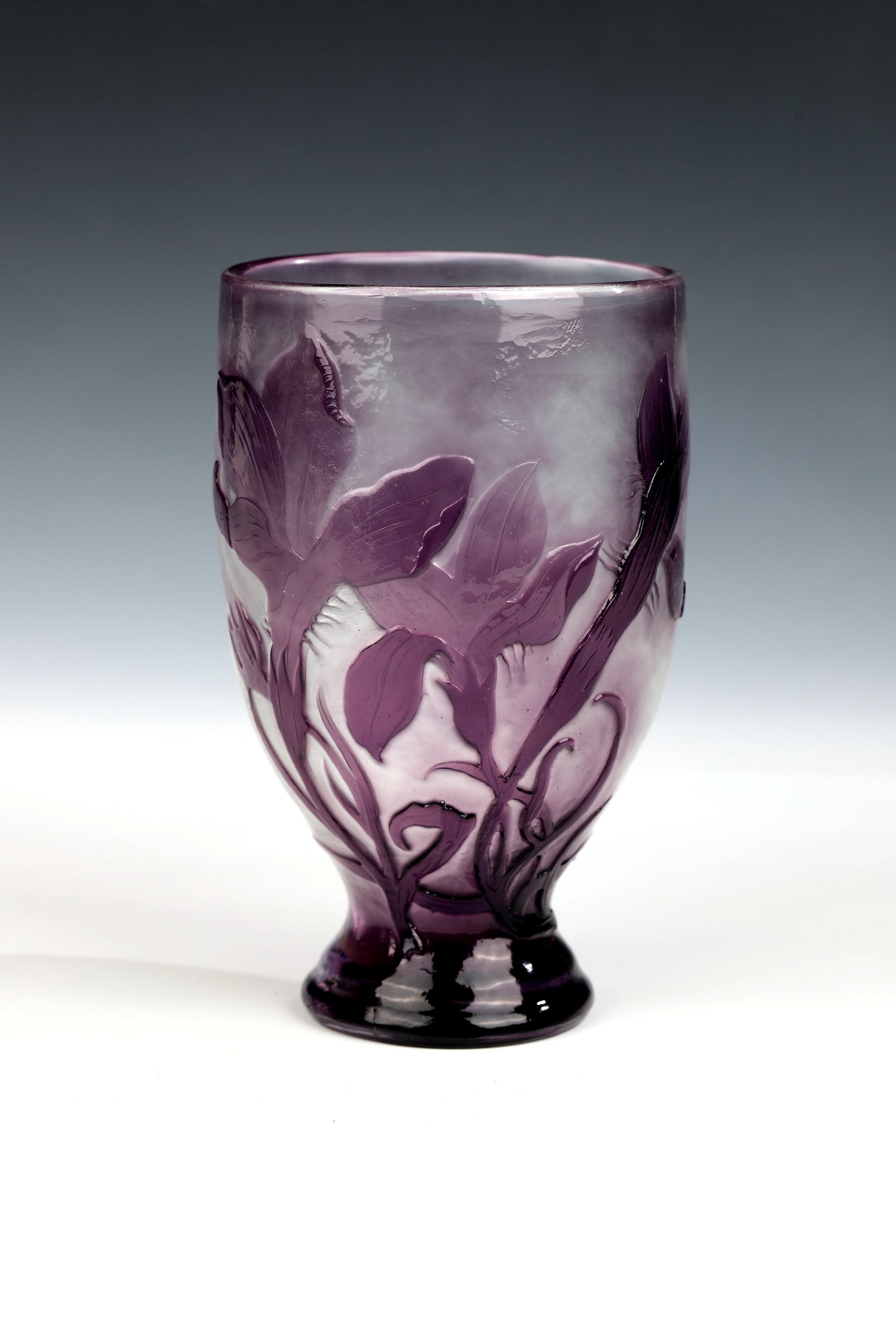 Beaker vase ''Magnolias'': Beaker vase ''Magnolias'' Emile Gallé, Nancy, 1894-1904 Colourless glass, overlaid with violet on the outside. Etched decoration in relief all around: flowers and foliage of the magnolia. Fire