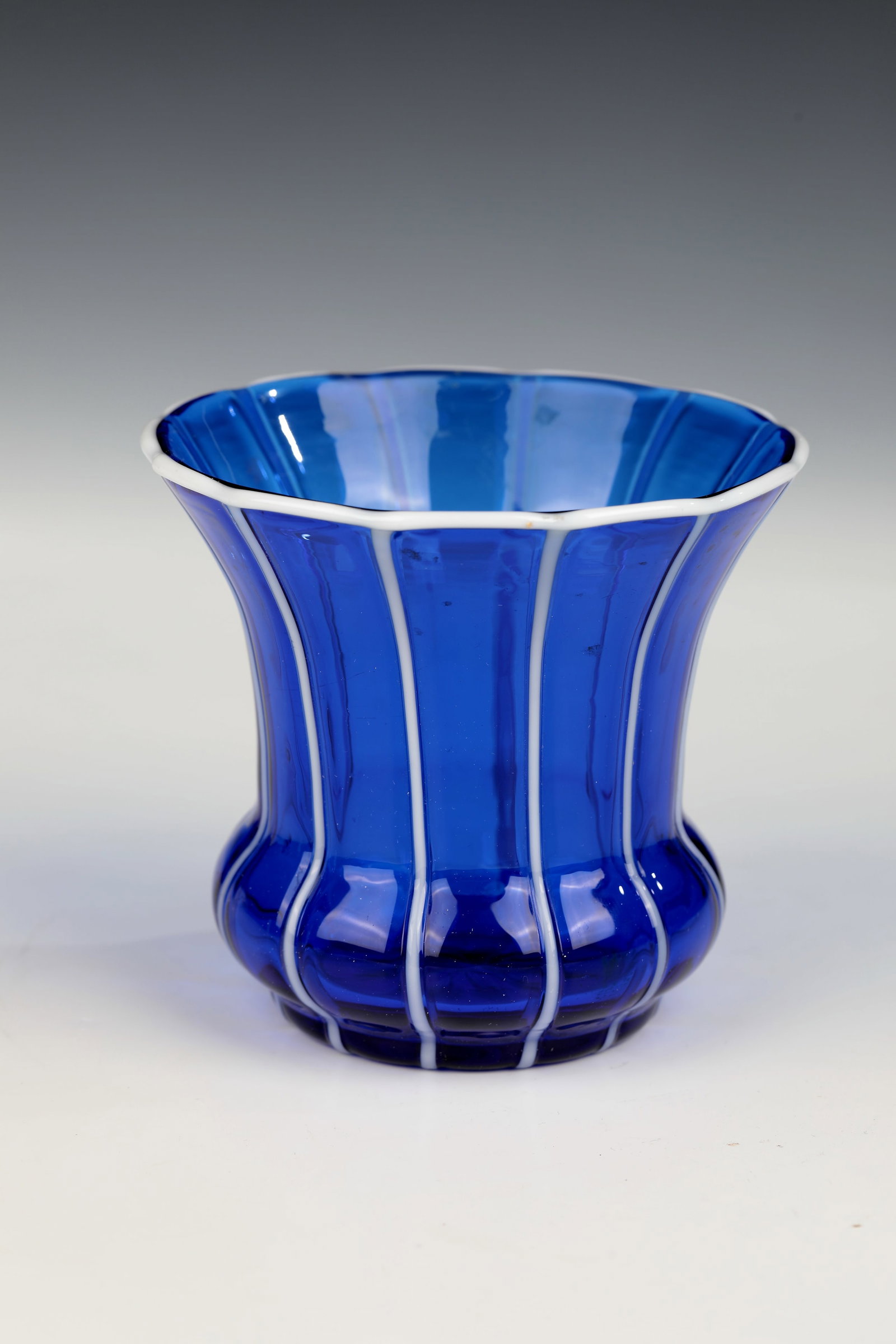 Vase ''Cobalt Blue with White Stripes Ausf. 157'': Vase ''Cobalt Blue with White Stripes Ausf. 157'' Loetz Wwe., Klostermühle, c. 1915 Cobalt blue glass with vertically applied threads in white opal. The passingly wavy muzzle rim with white