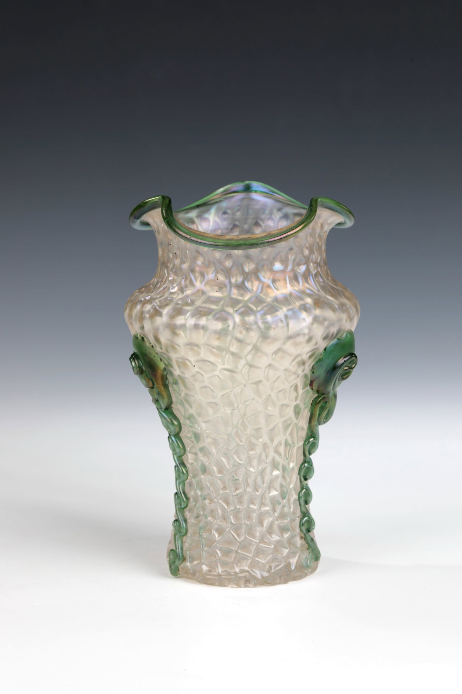 Vase: Vase Wilhelm Kralik Sohn, Eleonorenhain, c. 1900 Colourless, longitudinally blown glass. Iridescent body with triple wavy rim and melted lip rim as well as elongated green glass appliqués. H. 11 