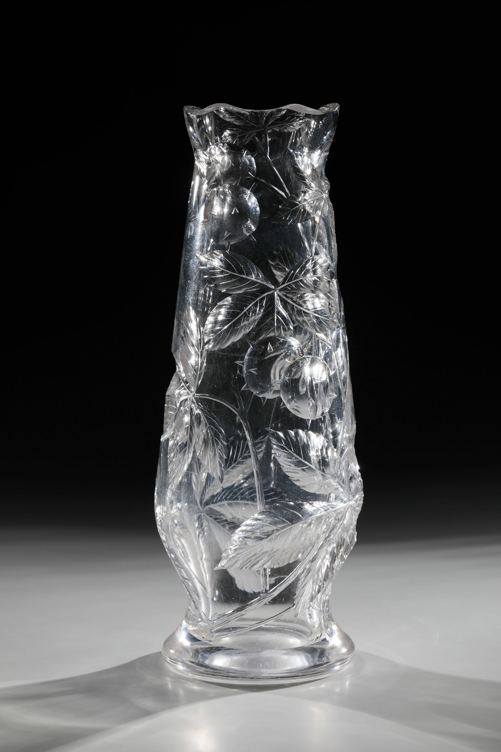 Vase: Vase Bohemia, c. 1900 Thick-walled, colourless glass with blown deep cut. Decor: chestnut branches and fruits. Corrugated muzzle rim. H. 31.5 cm Condition description: Stand ring with sliding tracks