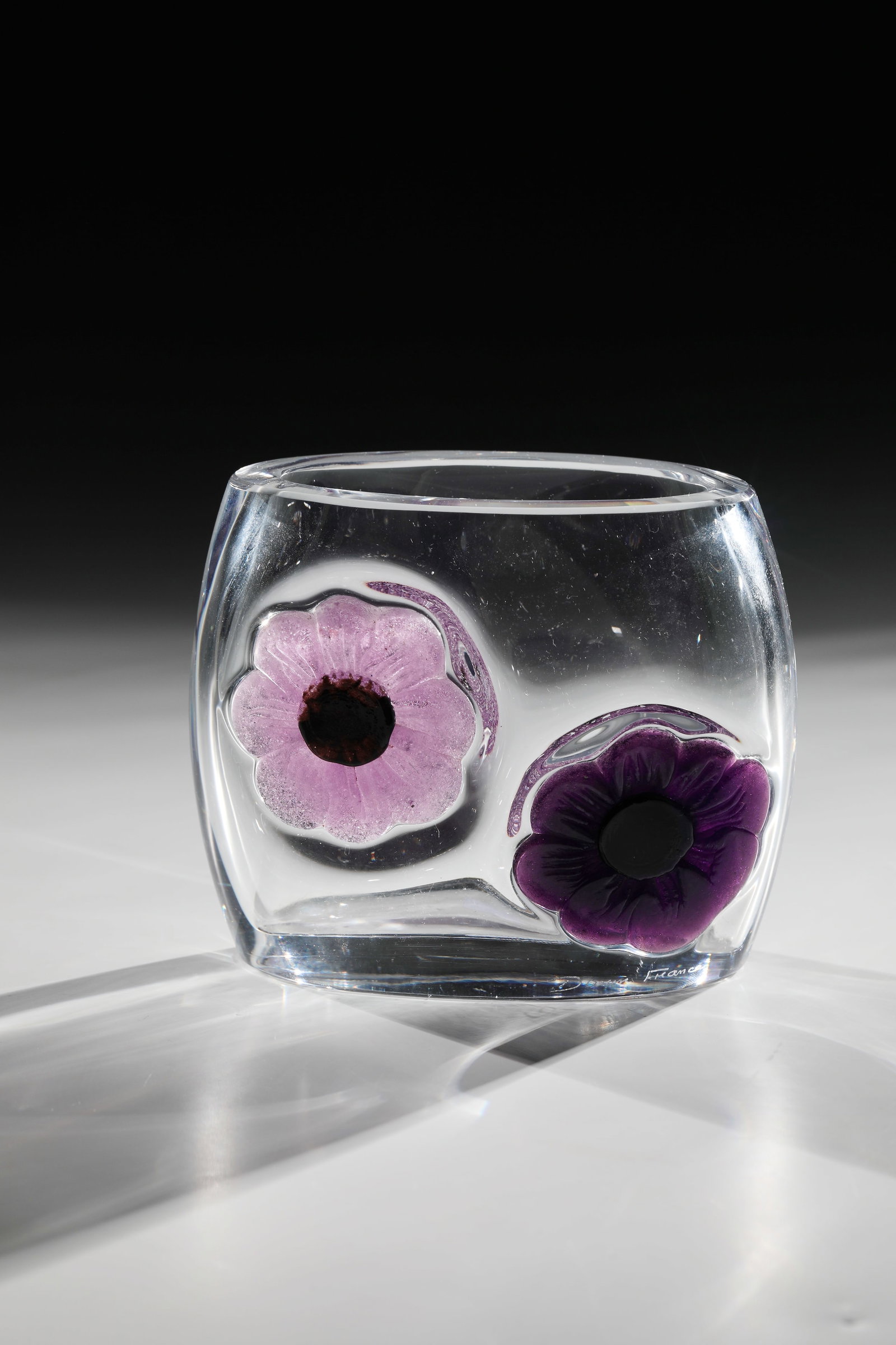Vase ''Coppelia'': Vase ''Coppelia'' Cristallerie Daum, around 1977 Thick-walled, colourless glass. On the wall melted décor: blossoms. Pâte-de-verre. Signed in engraving above the stand: Daum France. H. 11.5 
