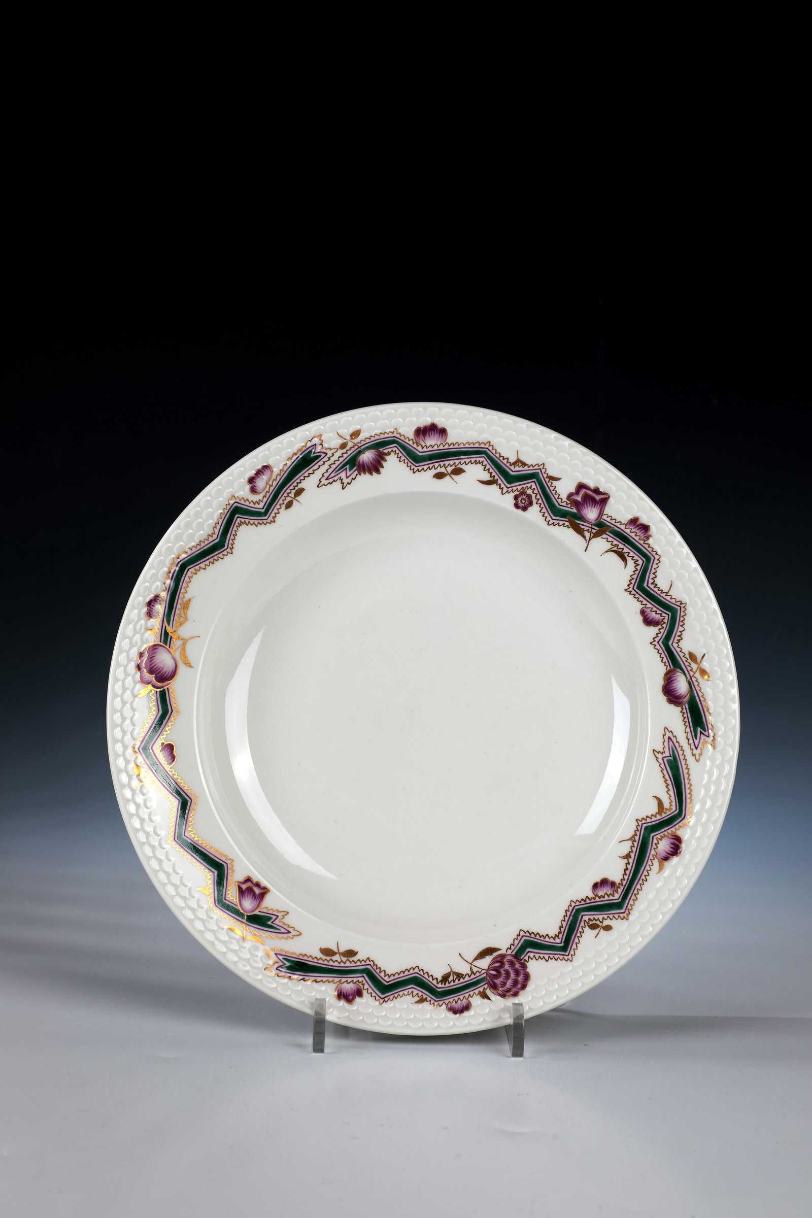 Deep Plate: Deep plate designed by Adelbert Niemeyer, Meissen around 1920 Porcelain with overglaze painting in cyclamen red and fir green with gold. Sword mark, 4501, 22 (blind embossing). d. 24 cm. Cf. Porzellan
