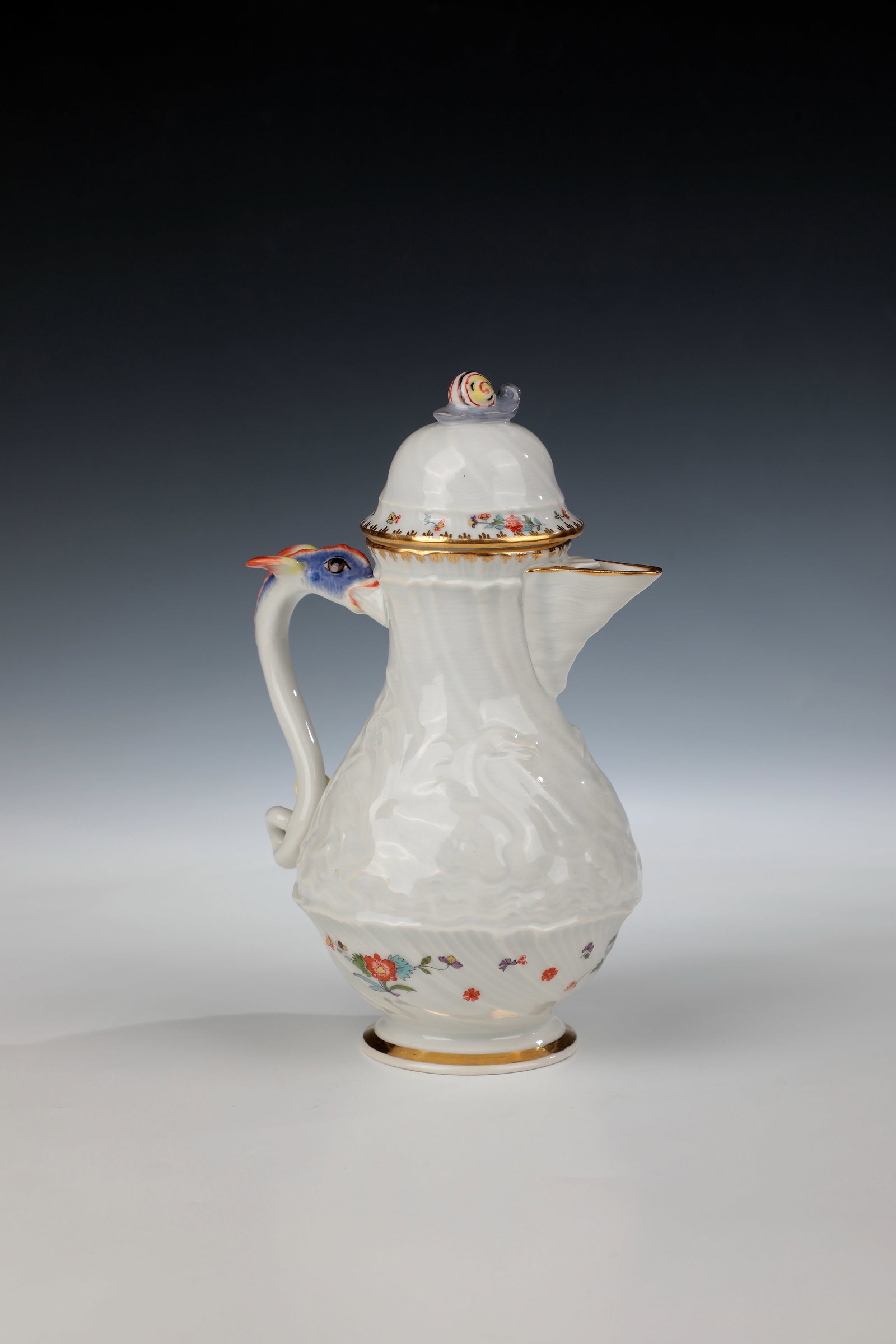 Mocha pot from the swan service: Mocha pot from the Swan Service Meissen, 20th century Pear-shaped body with hood lid. Figurative handle and lid knob as dolphin or snail. Decor: Swan service with Indian flowers in polychrome
