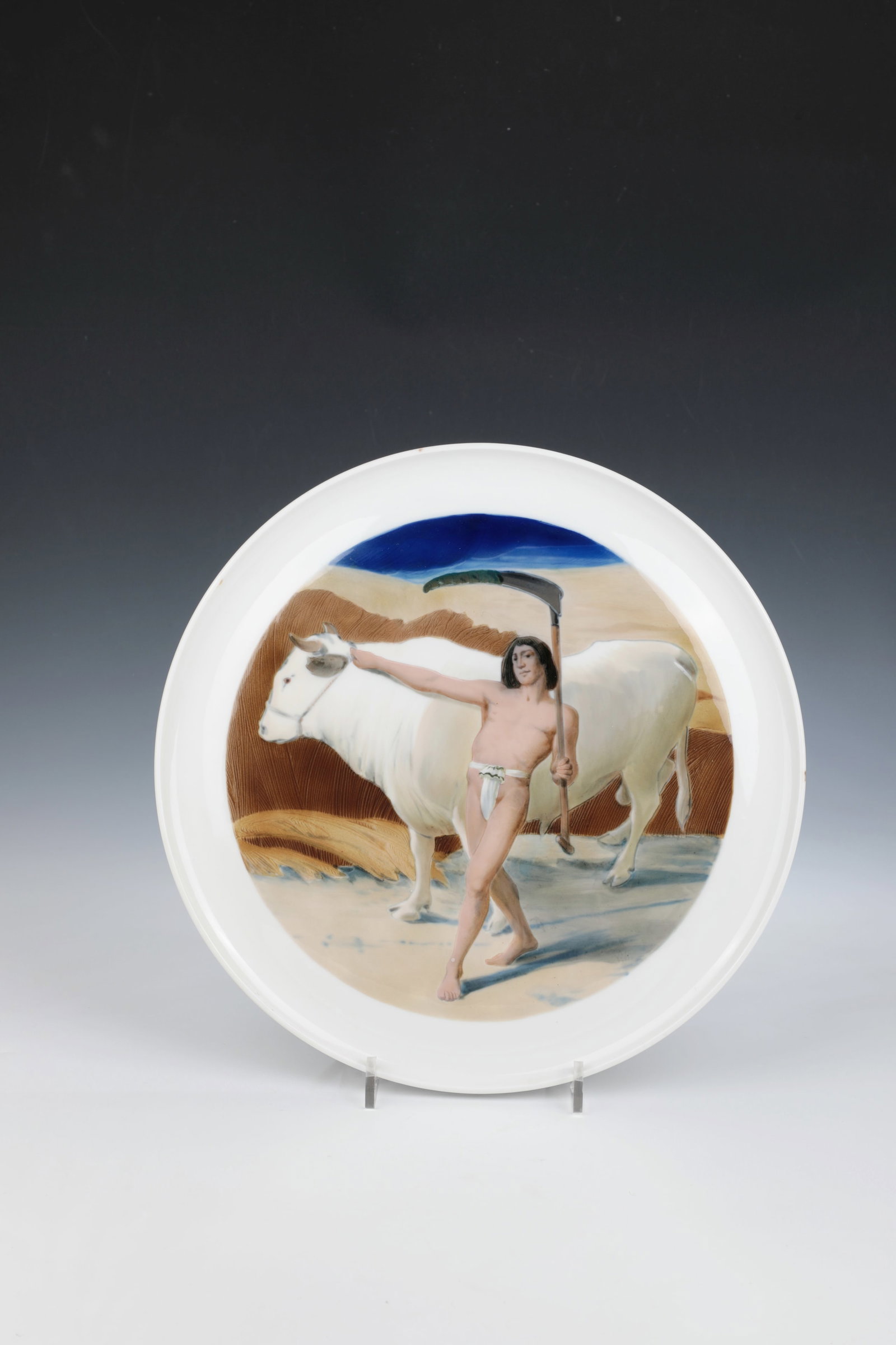 Large Picture Plate: Large picture plate designed by Martin Wiegand, Meissen around 1909 In the mirror polychrome sharpfire painting: at a wheat field, an Egyptian farmer with a scythe, leading a bull. On the flag,