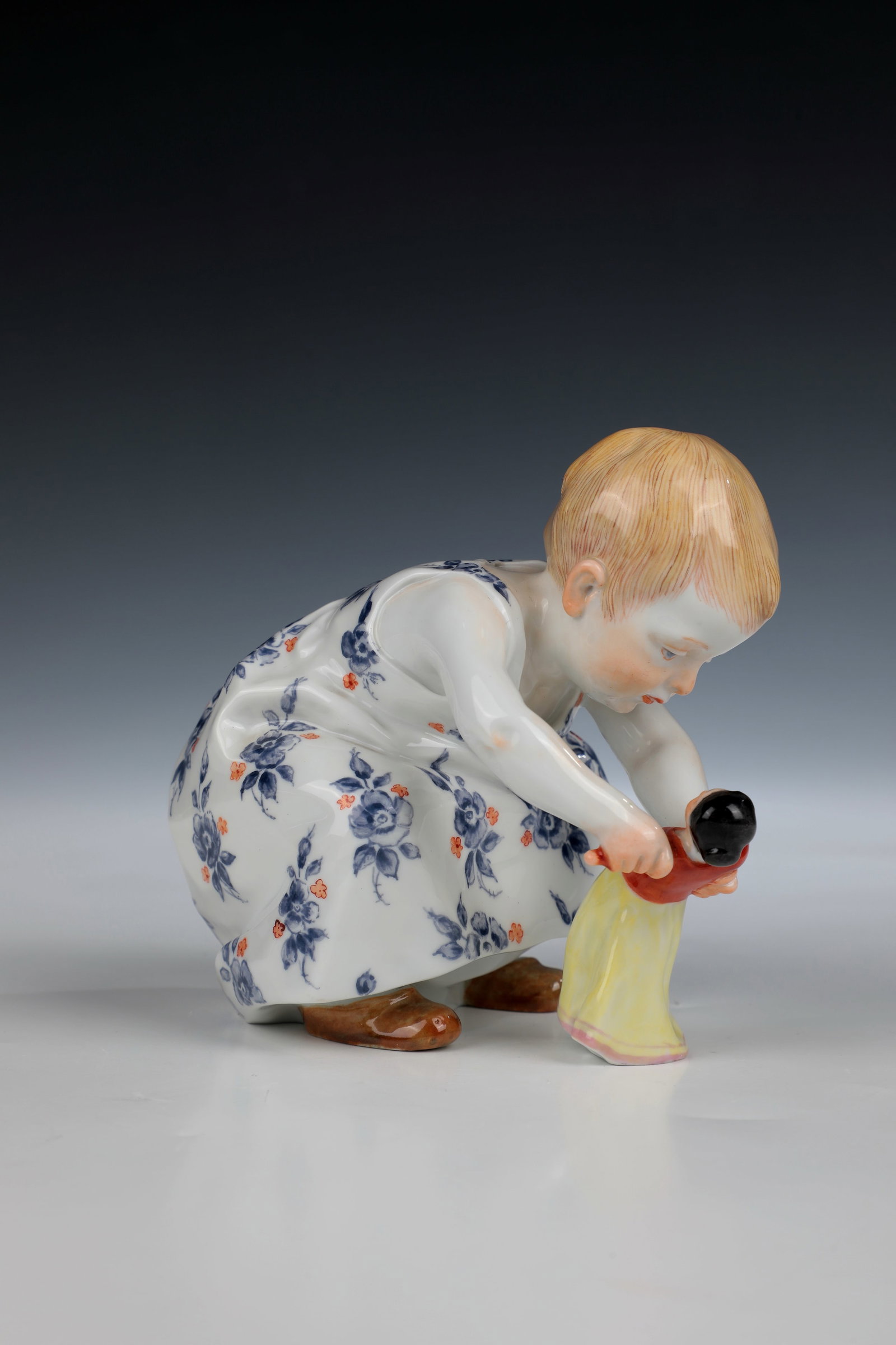Hentschel child with doll: Hentschel child with doll, designed by Konrad Hentschel 1904, Meissen after 1973, polychrome overglaze painting. Sword mark. Model No. 73363. H. 12cm.