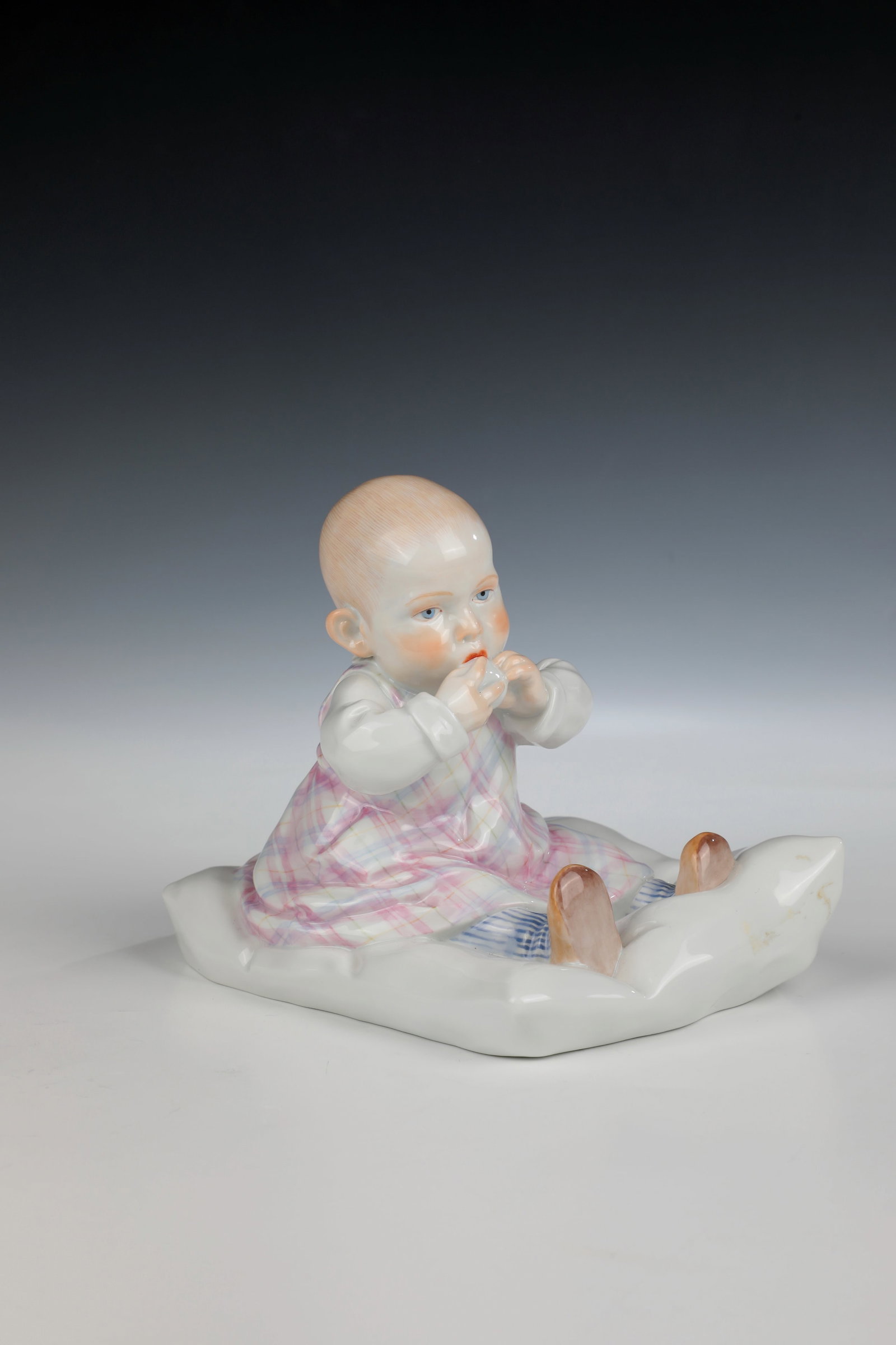 Hentschel child on pillow: Hentschelkind on cushion designed by Konrad Hentschel 1904, Meissen after 1973 polychrome overglaze painting. Model No. 73355, sword mark. H. 12.5cm. Cf.: Cat. Bröhan Museum, Vol. II, No. 457.