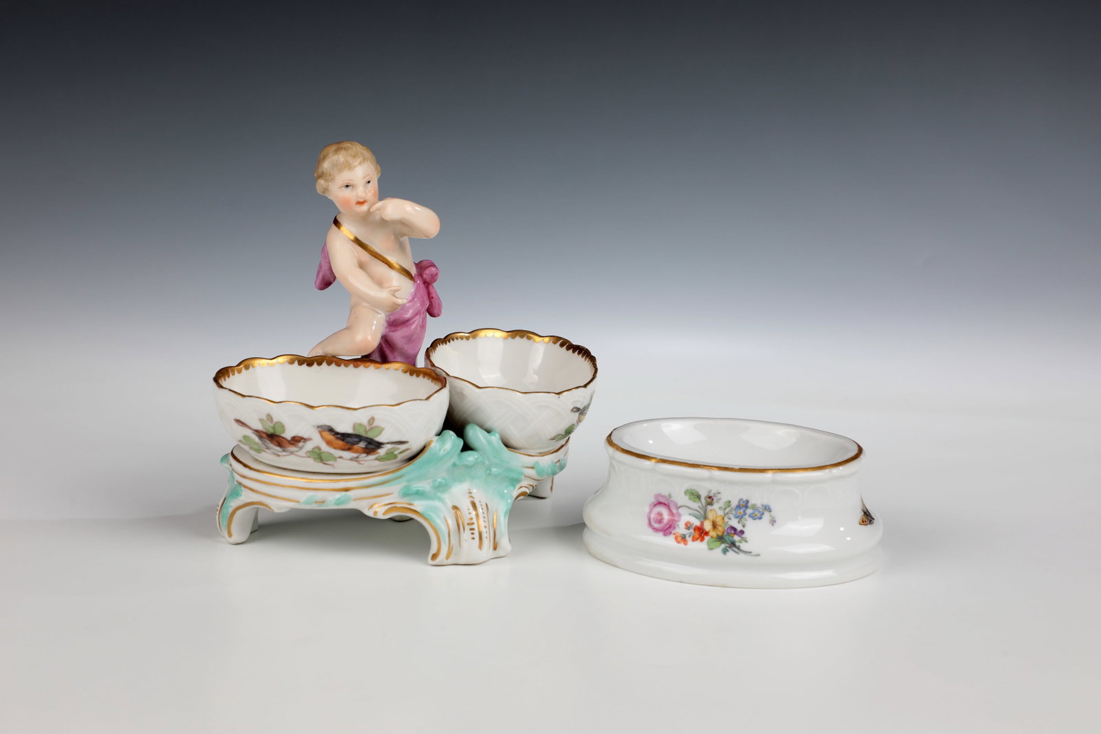 Spice cruet with ''salt licker'' and spice bowls: Spice menage with ''salt licker'' and spice bowls Designed by Friedrich Elias Meyer, KPM Berlin c. 1770-80 Two oval spice bowls with bird motifs on rocaille bases, in the middle a putto, the left