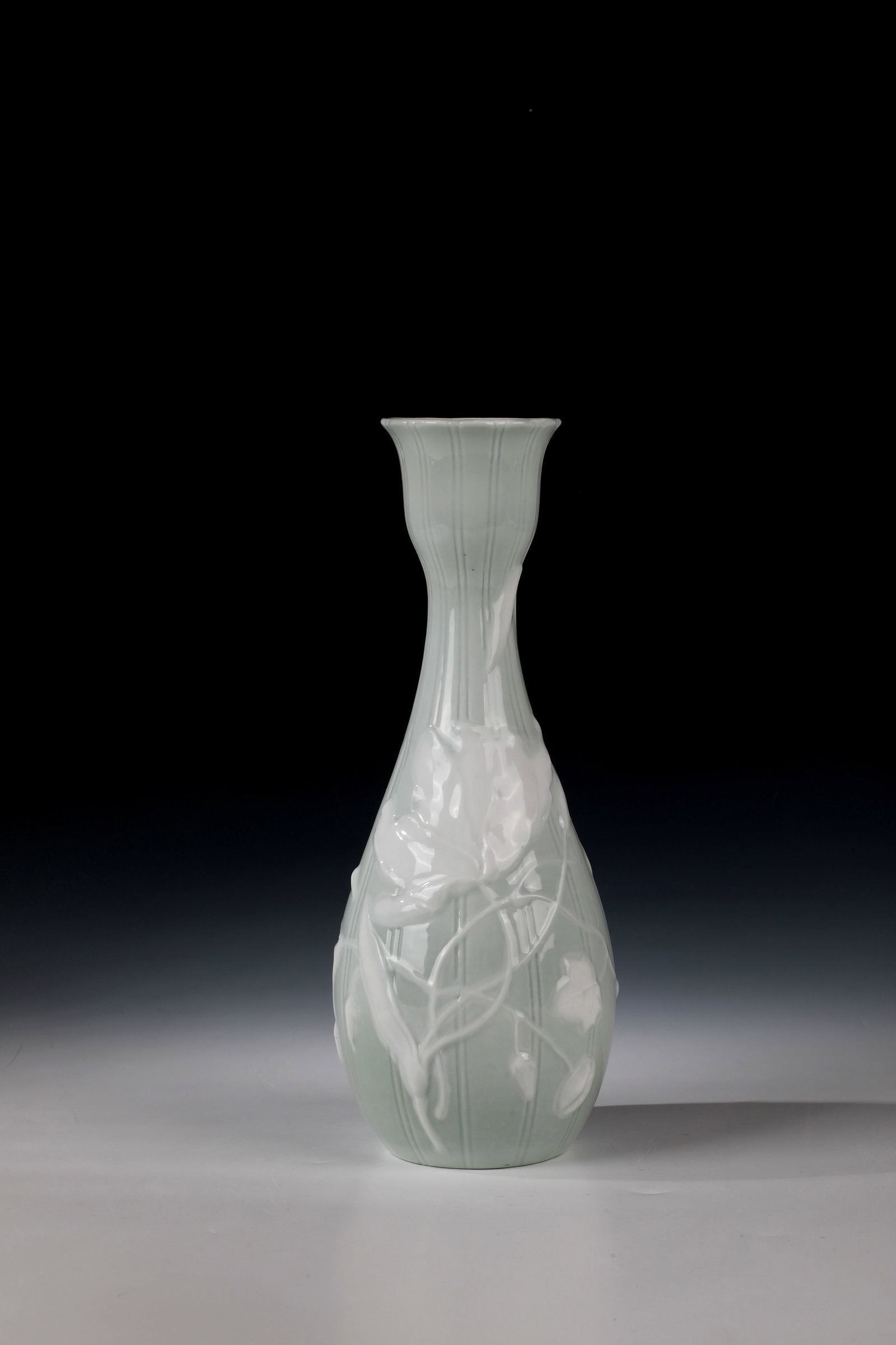 Vase: Vase KPM Berlin 19th century Relief morning glory decoration in front of a celadon green background with vertical, incised line pattern. Minimally damaged. Scepter and penny stamp. H. 31cm.