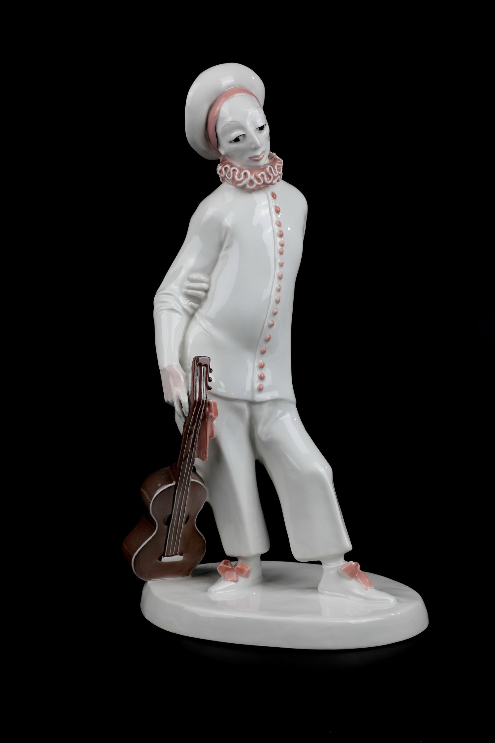 Pierrot with guitar: Pierrot with guitar Josef Wackerle (design) 1910, KPM Berlin Standing, weight shifted to the right leg, guitar casually in hand, oval base plate. Porcelain, white glazed, with pink and brown