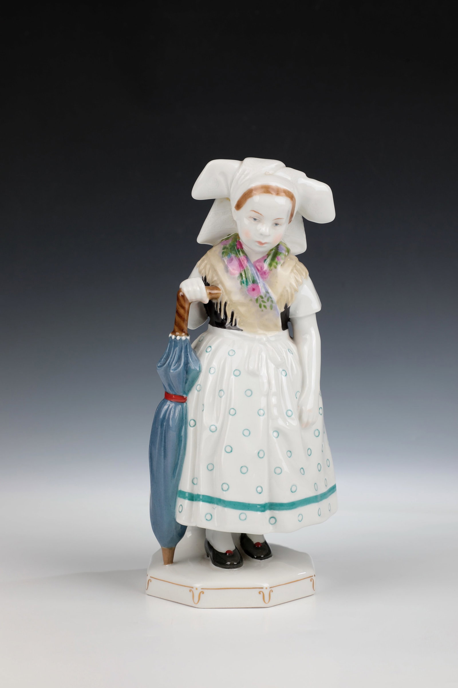 Spreewald Child with Umbrella: Spreewald Child with Umbrella Designed by Karl Himmelstoss 1908, KPM Berlin 1909 Girl standing on an octagonal pedestal in traditional costume in polychrome painting. Model No. 8946. Artist's