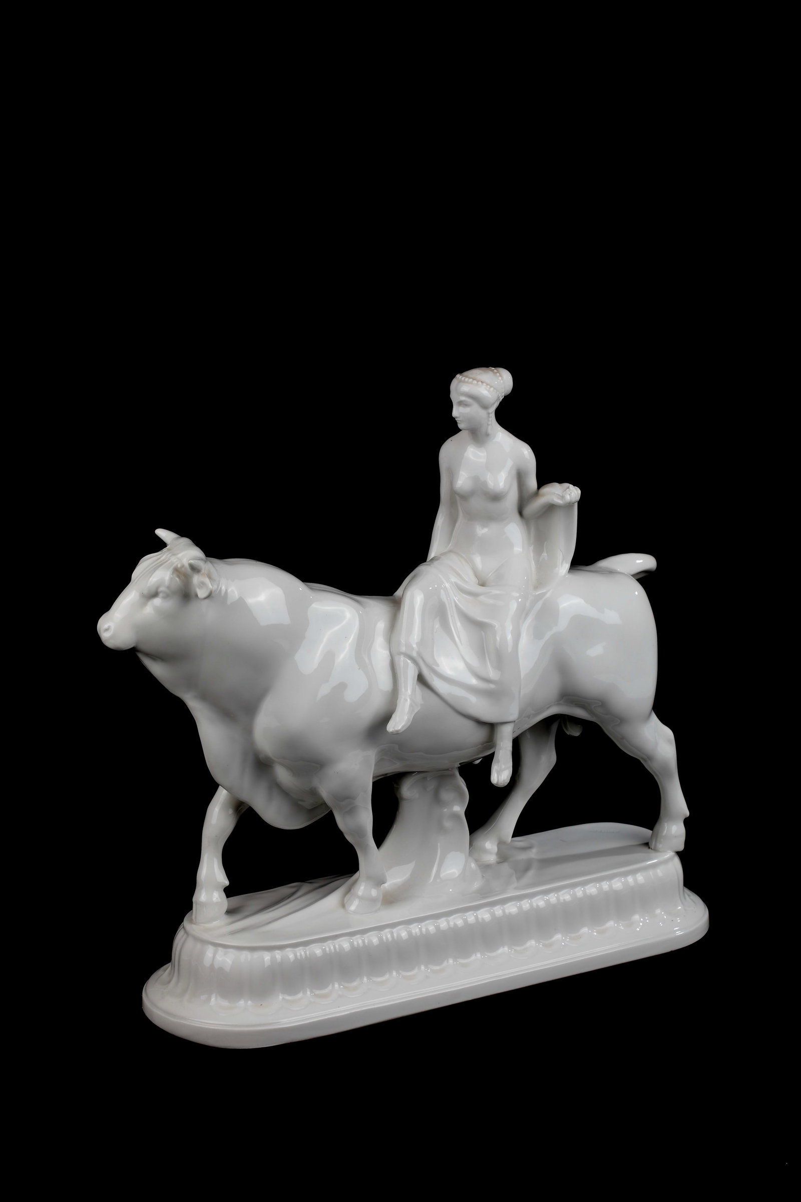 Bride as Europe on the bull: Bride as Europe on the Bull Designed by Adolf Amberg 1908, KPM Berlin 1909 On a longitudinal oval base with profiled edge and arch motif. Bride with festive hair ornament and scarf, riding on a bull.