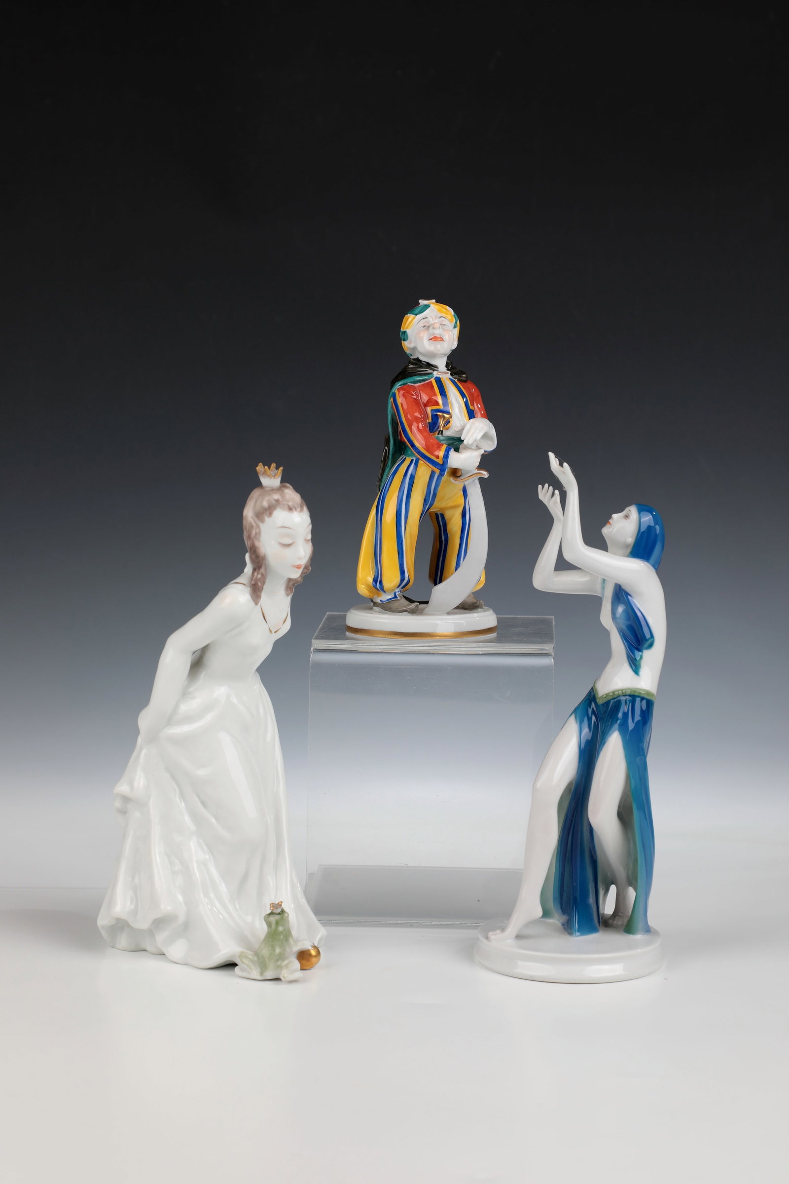 Three figures: Three figures Rosenthal, early/mid-20th century Consisting of Frog Queen: Frog Queen in floor-length robe bowing down to the Frog Prince. Minimally chipped, designed by Lore Friedrich-Gronau, model no