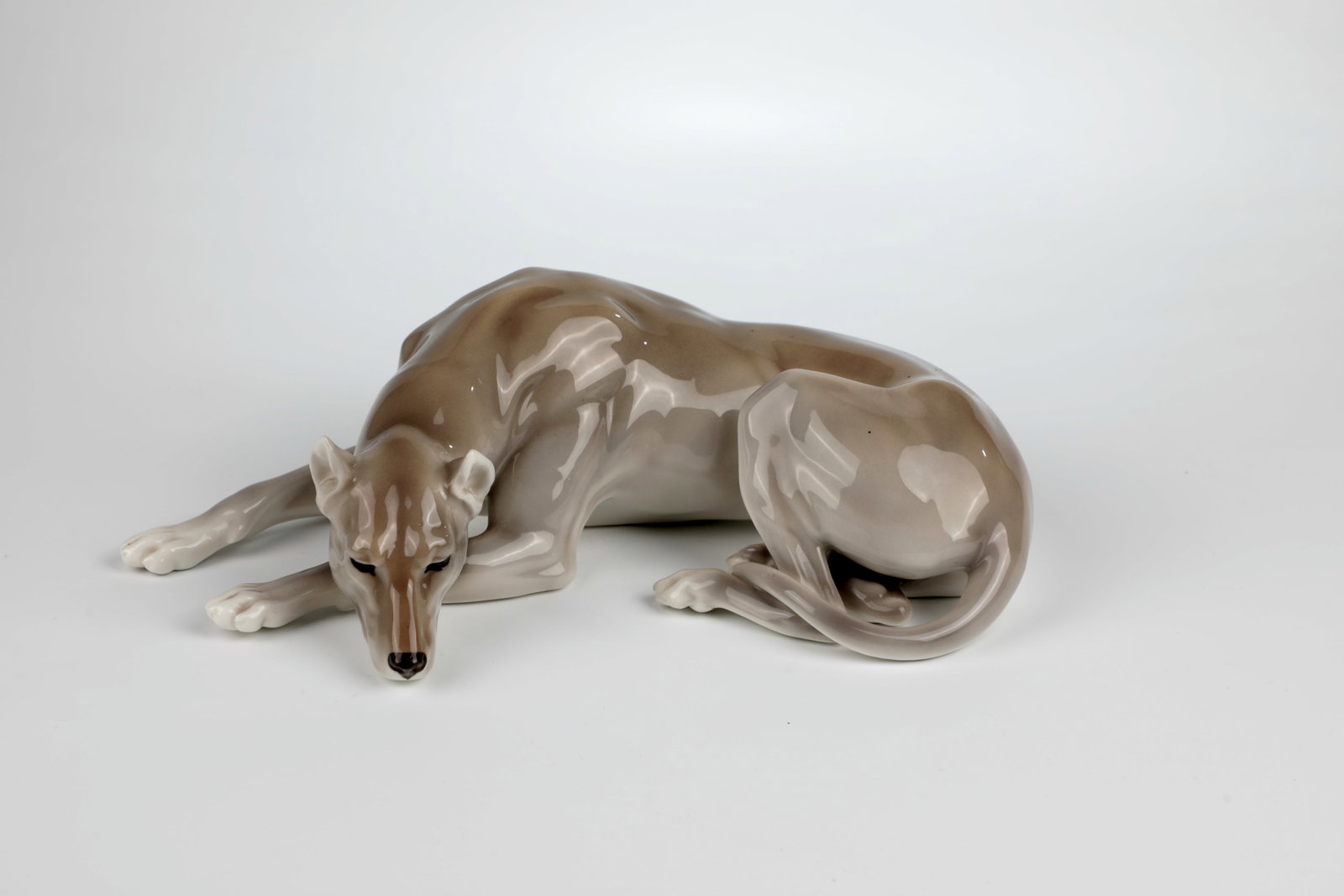 Reclining Great Dane: Reclining Great Dane Enrwurf Theodor Kärner 1908, Nymphenburg Reclining Great Dane in naturalistic underglaze painting. Model No. 151 (scored) and diamond mark (embossed). L. 24.5 cm. Cf.
