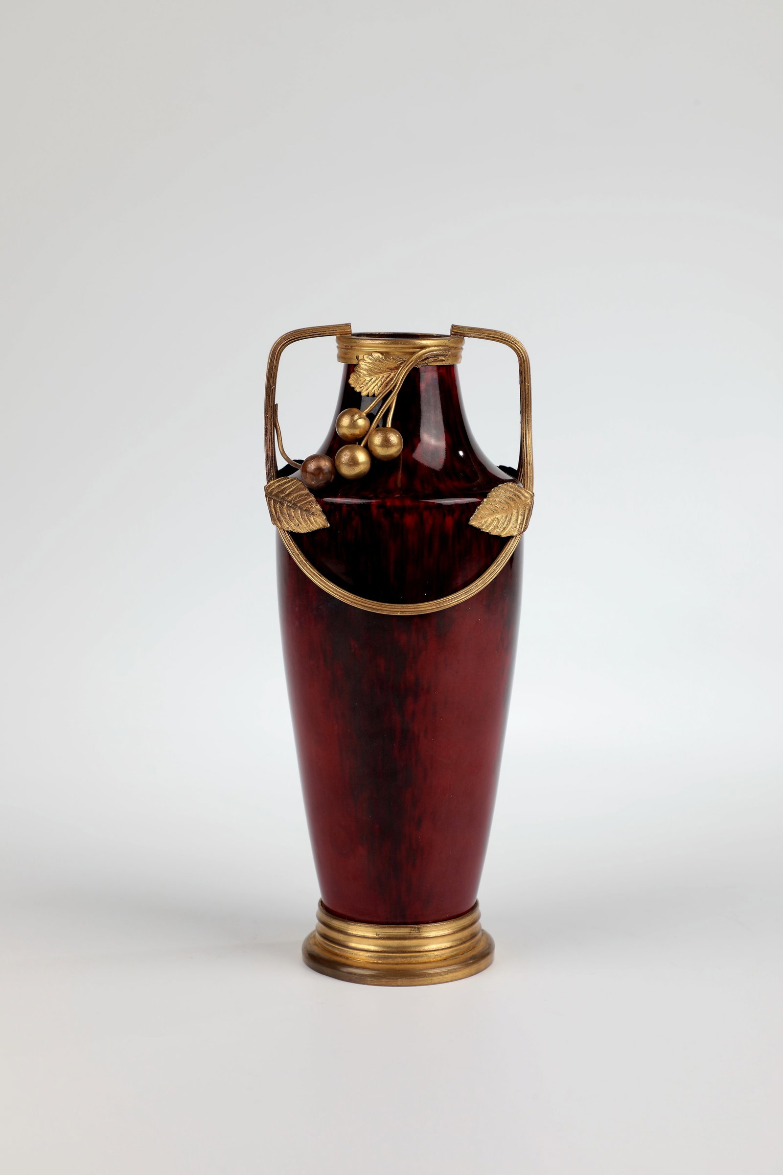 Vase: Vase Sèvres, c. 1900 Blood-red porcelain with bronze mount with leaves and fruits. H. 21 cm.