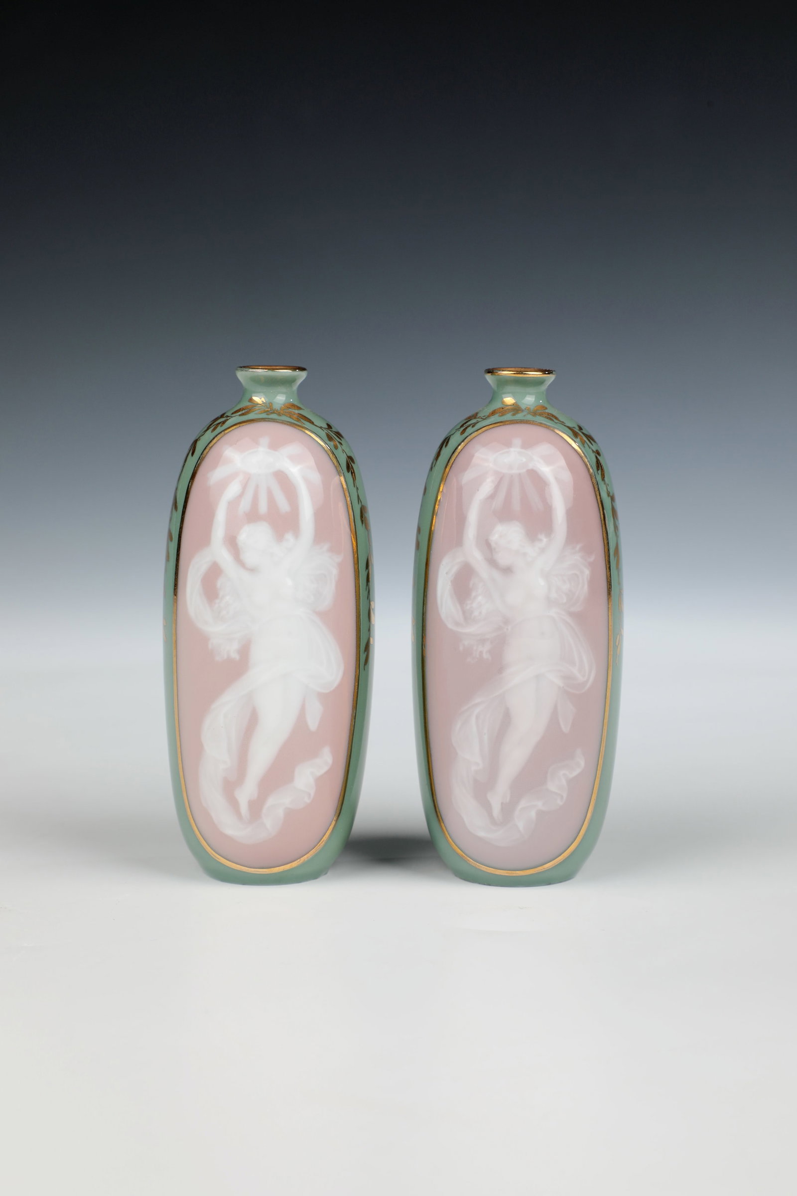 Two small vases: Two small vases Heubach Brothers, Lichte, c. 1905 Pate-sur-Pate, lime green and old pink background, fine translucent depiction of an antique-style nymph with a halo of rays, floral gold staffage. H.