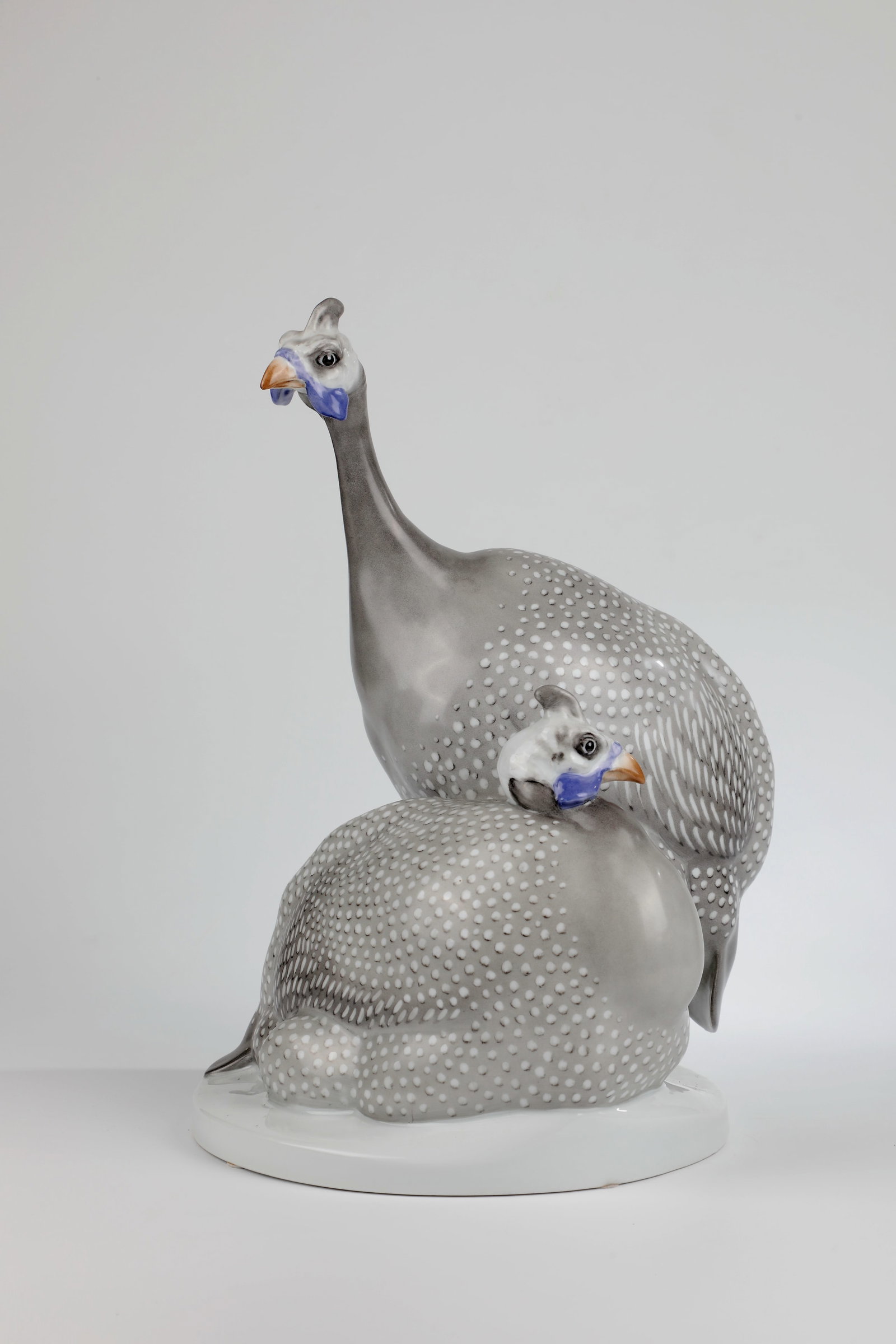 Guinea fowl: Guinea fowl designed by Max Esser around 1910/11, Schwarzburger Werkstätten On a round base A pair of guinea fowls in polychrome, naturalistic underglaze painting. Base with hairline cracks. H.