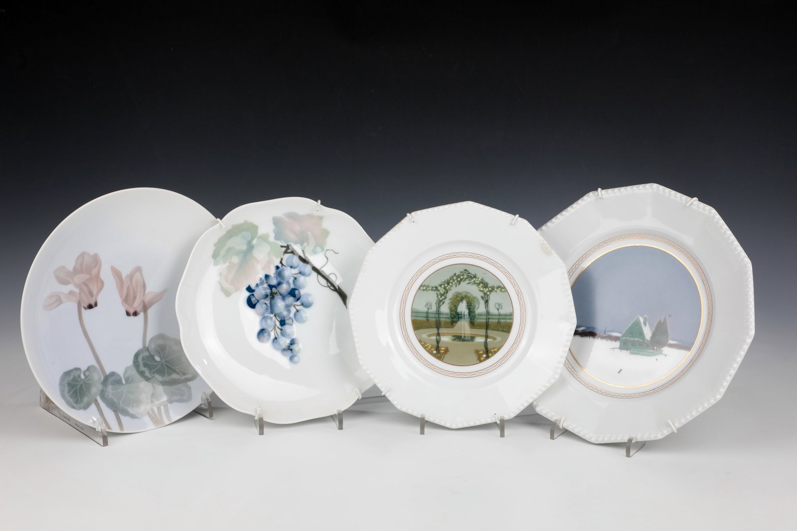 Four plates: Four plates including Nympenburg, early 20th century 1.: ''Rosengärtlein'' - ornamental plate from the series ''Perl'' with landscapes, designed by Rudolf Sieck, Nymphenburg 1906. D. 21.5 cm.