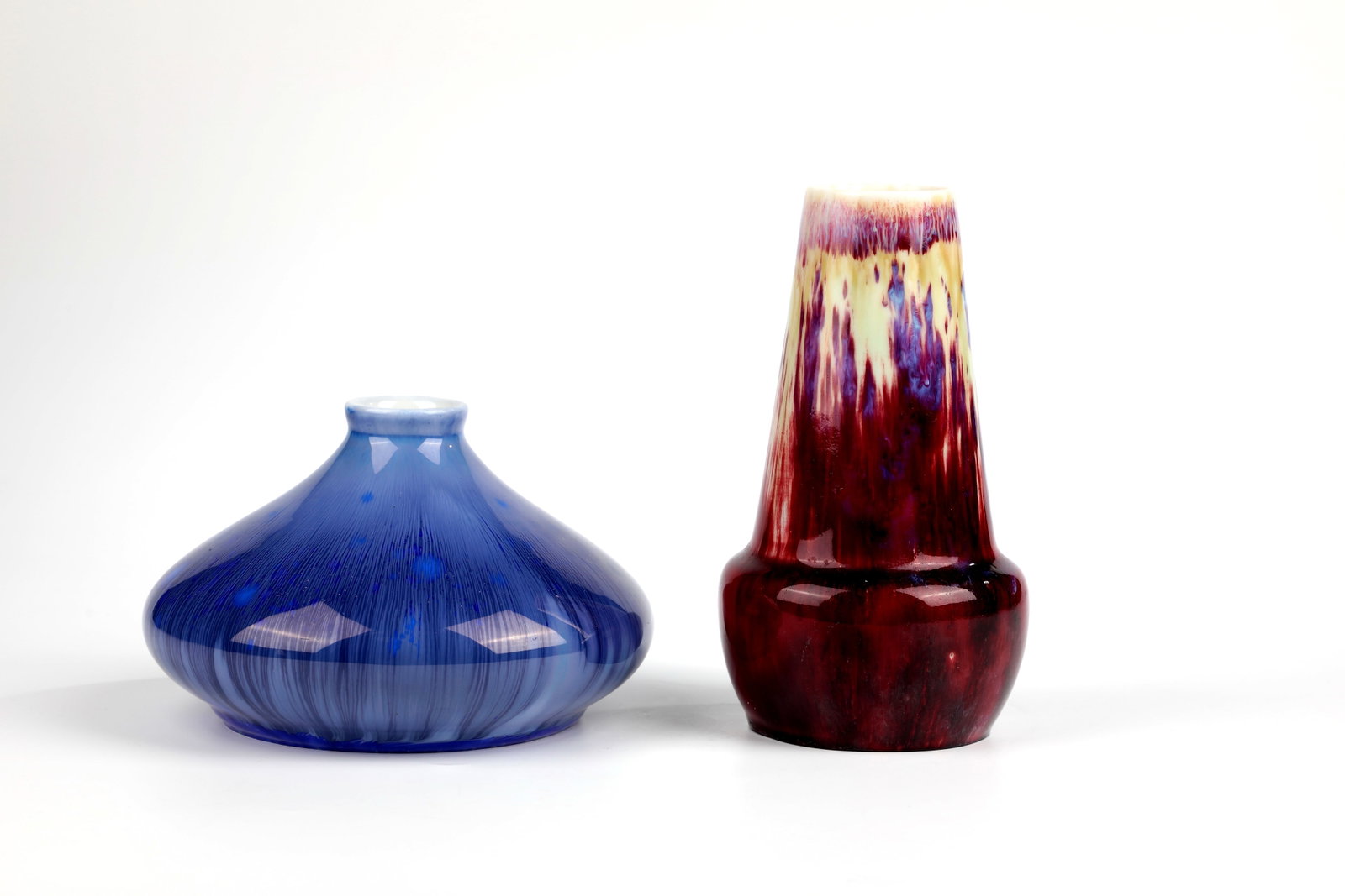 Two vases: Two vases KPM Berlin 1899 and Royal Copenhagen 1924 vase, KPM Berlin, Segerporzellan. Red glaze with white spots. Scepter mark with Seger stamp. H. 18 cm. Vase, designed by Paul Proschowsky, Royal Cop