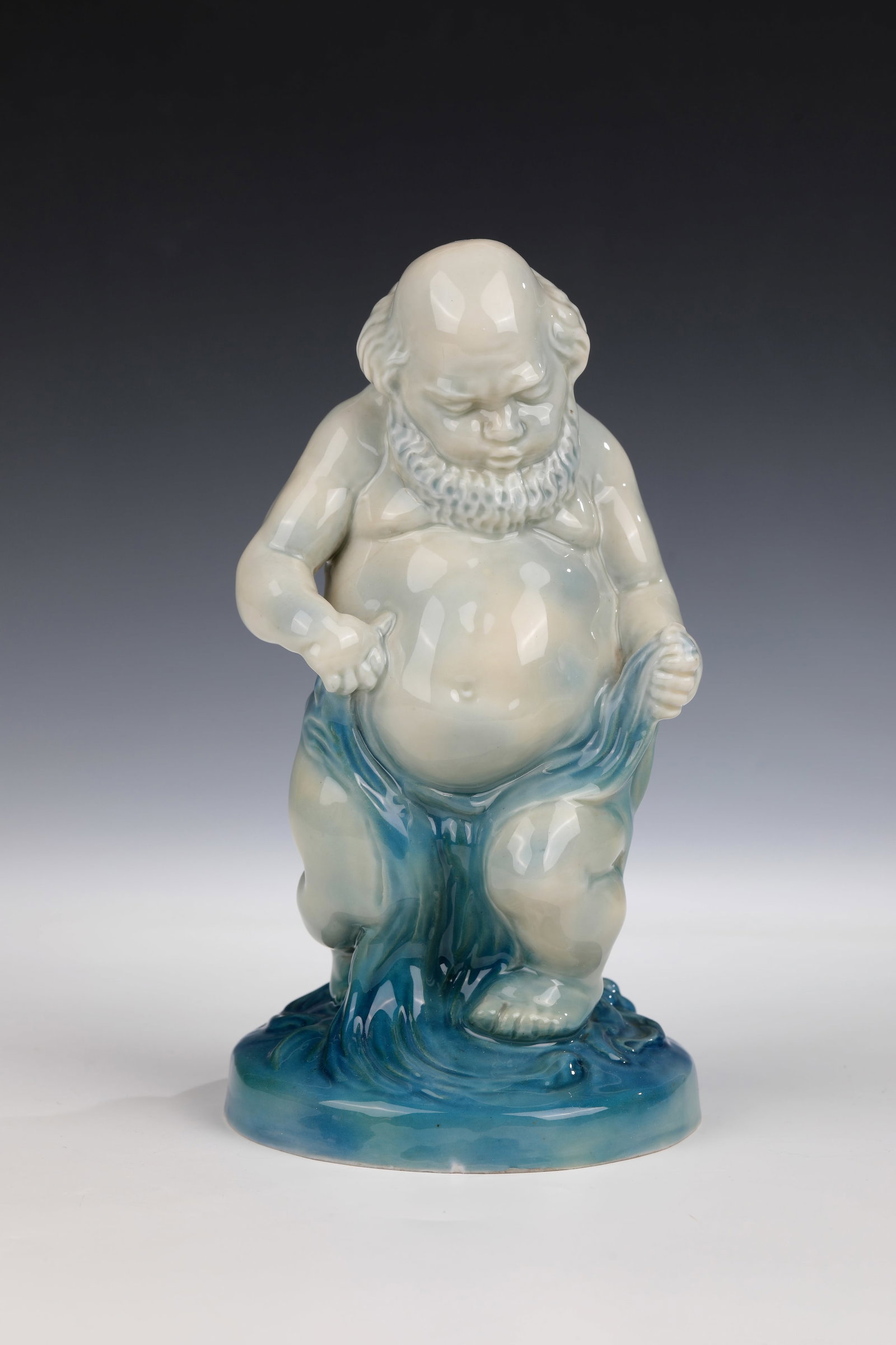 ''Triton'': ''Triton'' designed by Carl Brunotte 1916, Heubach brothers around 1916 Depiction of the Triton, god of the sea, rising from the waves. In discreet, blue painting. Manufactory mark in the bottom,