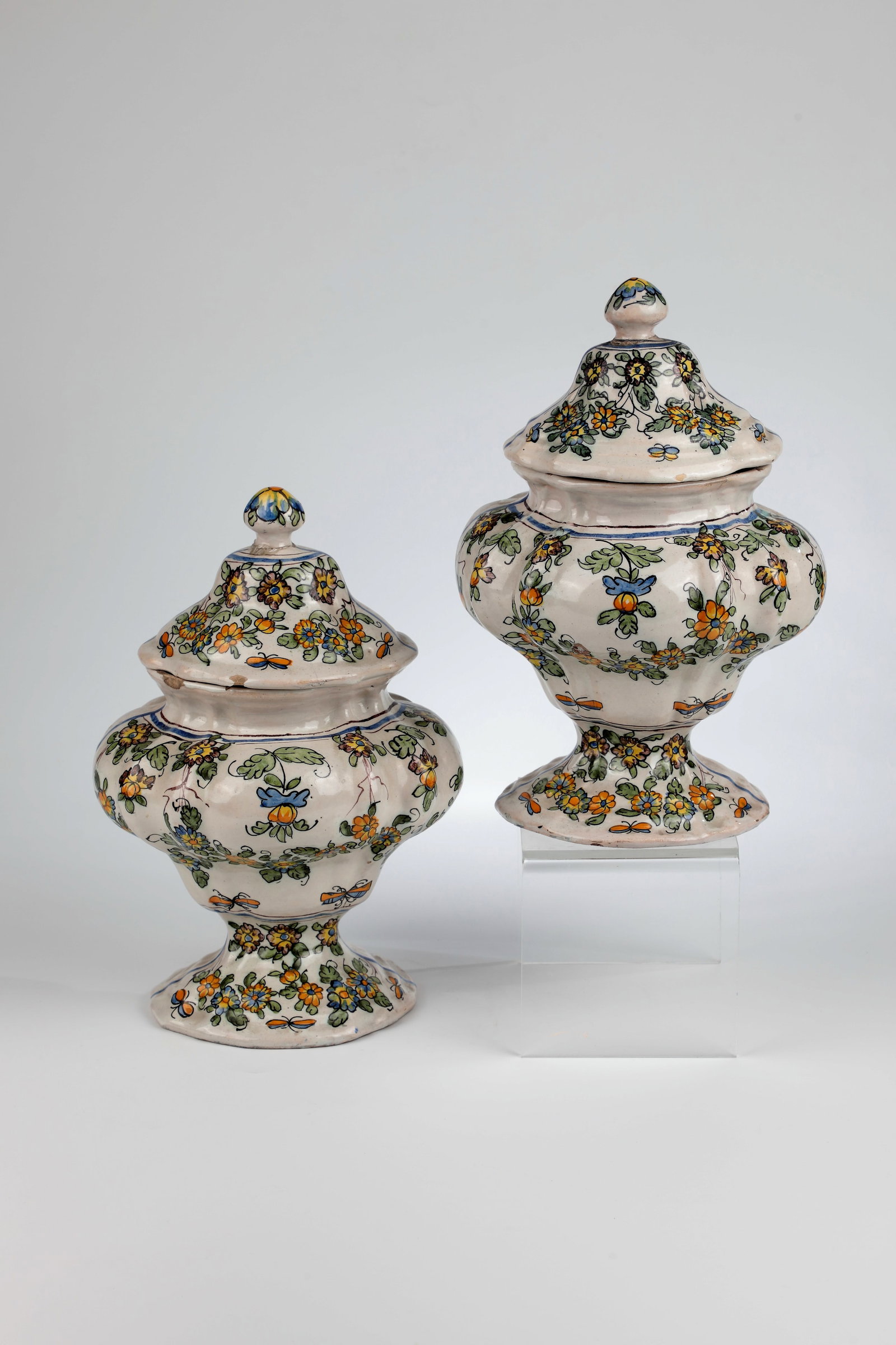 Pair of Majolica Lidded Jars: Pair of majolica lidded vessels Italy, probably workshop Cerreto Sannita, dated 1742 Urn-shaped, oval in cross-section with floral decoration in blue, green, yellow and oker. Dated ''1742'' in blue