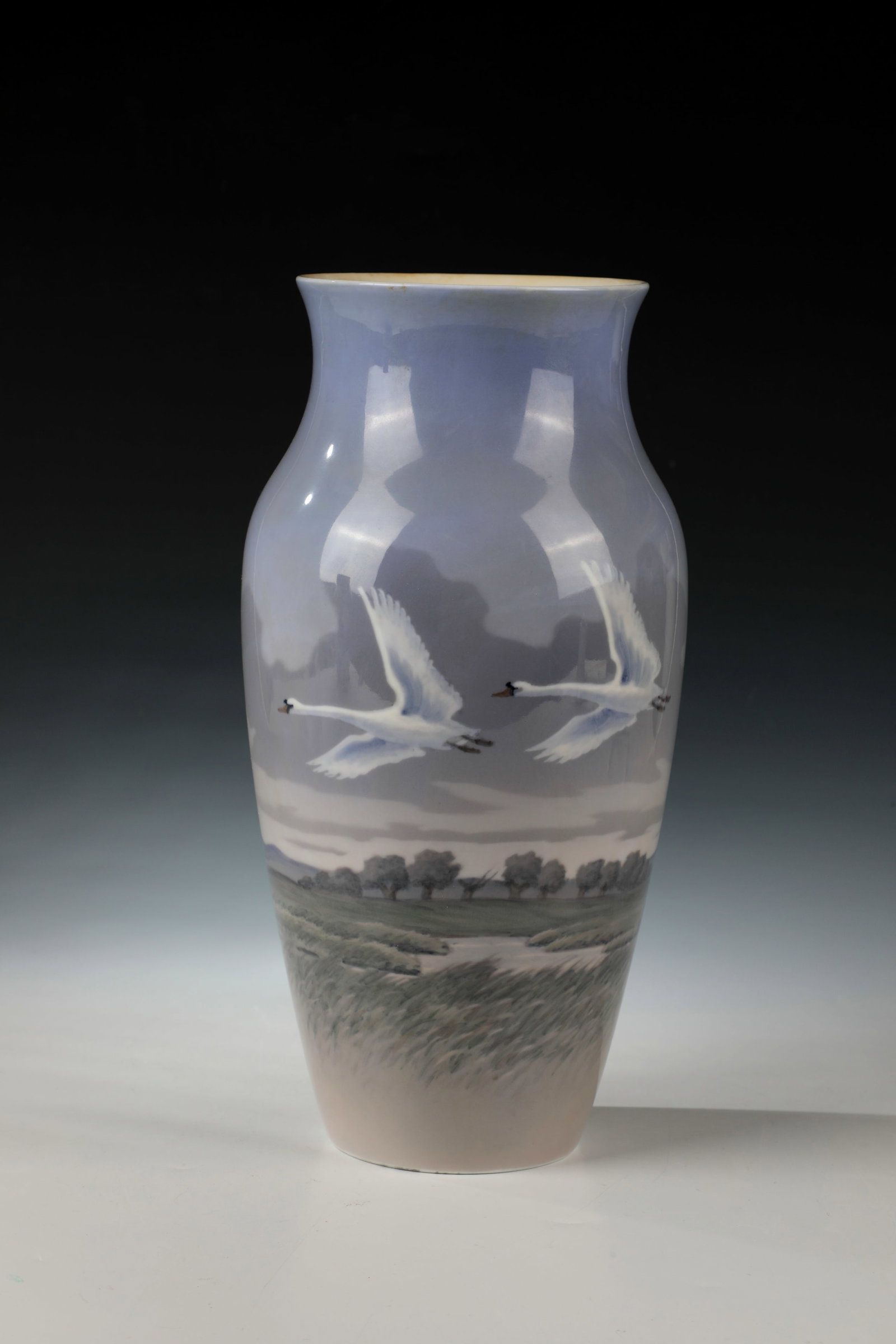 Large Vase: Large Royal Copenhagen 1957 vase porcelain vase with polychrome landscape decoration and two flying swans. In the bottom, green stamp and blue wave mark as well as model number and décor number.