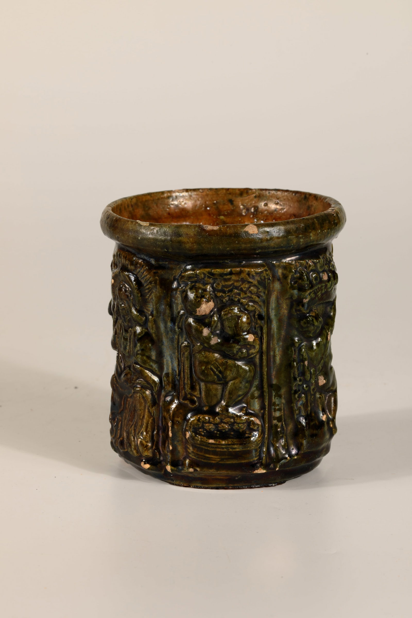 Seasonal Mug: Seasonal cup German, E. 19th century. Green glazed. On the almost cylindrical wall, allegorical representation of the seasons as well as depiction of saints and coat of arms in relief. H. 10 cm