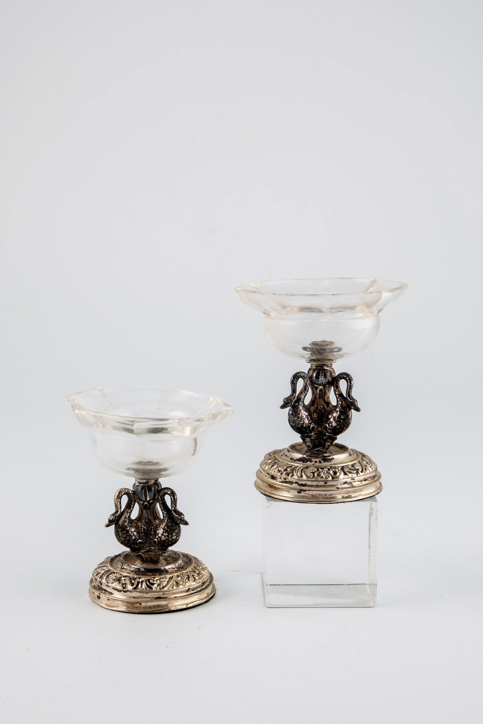 Pair of Spice Bowls: Pair of Spice Bowls, Prague, c. 1830 Round silver base with relief vine decoration. Shaft of three three-dimensional swans. Faceted, round bowls. Master brand. Height 9.5cm.