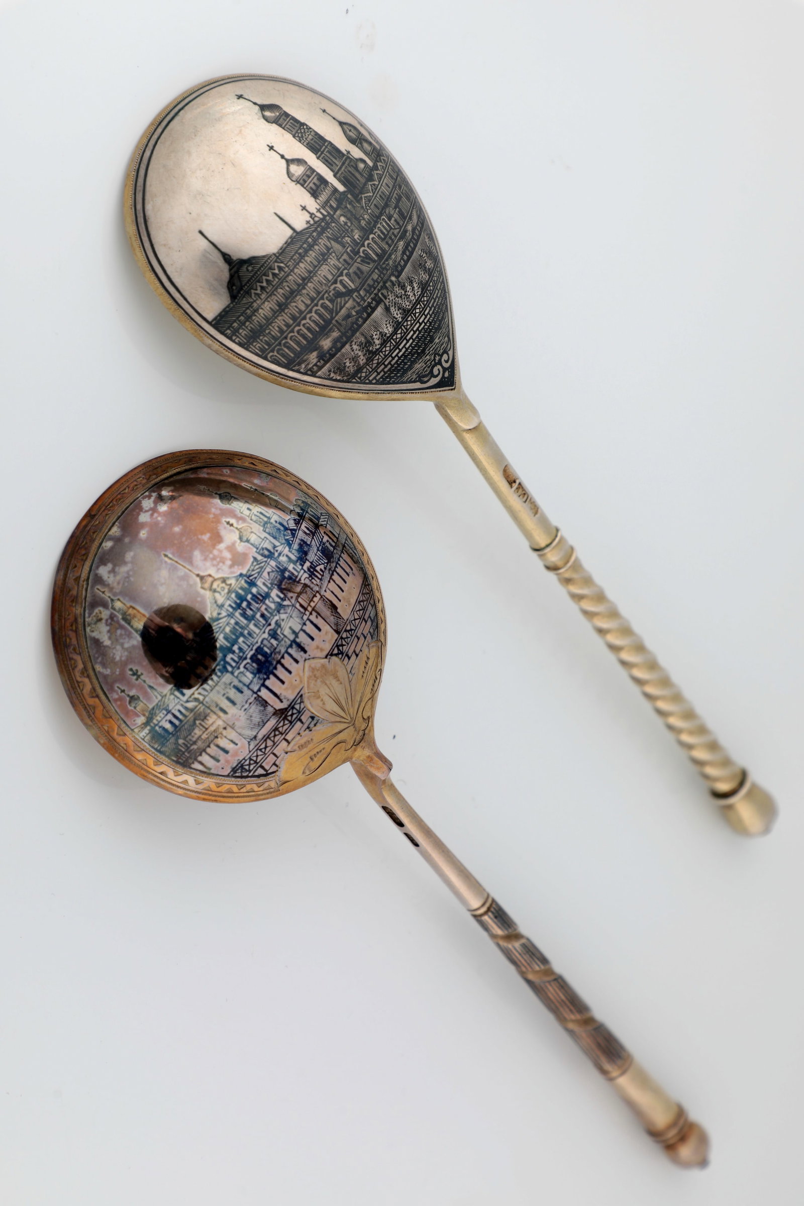 Pair of Large Silver and Niello Spoons: Pair of large silver and niello spoons Russia, Moscow, late 19th / early 20th century, silver, partially gilded. Gaps with niellated views. Indistinctly hallmarked with city mark, fineness ''84''. L. 