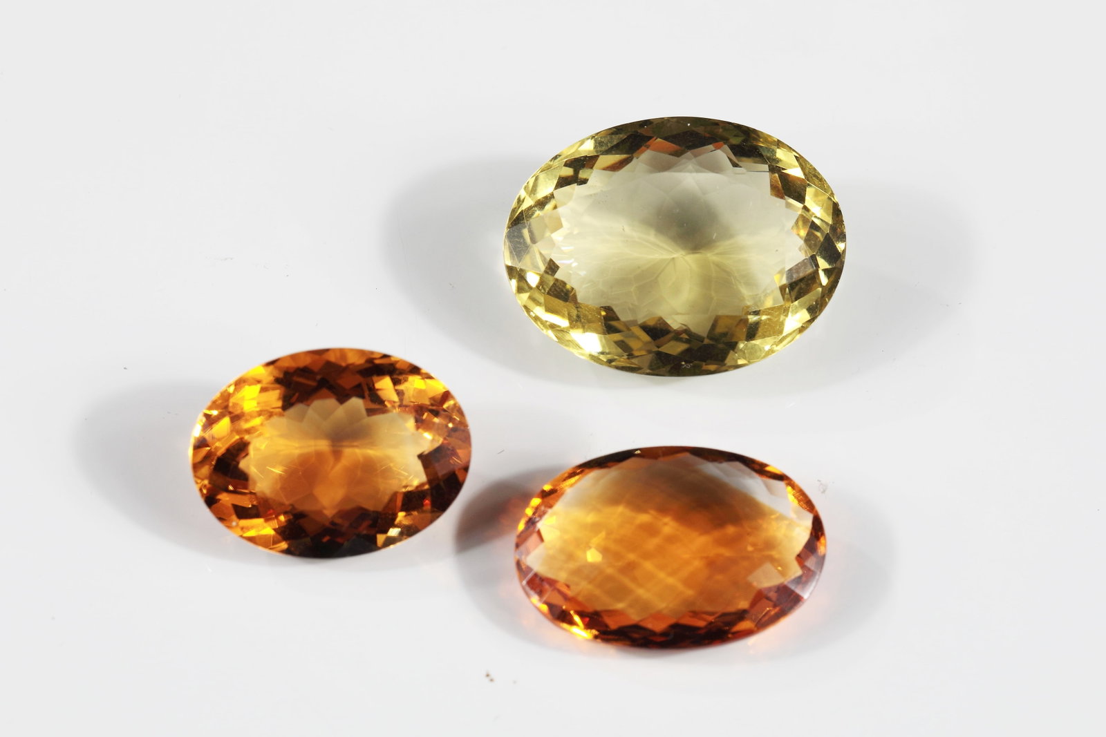 Citrine: Citrine Three monochrome, faceted citrines, two orange and one greenish yellow. L. approx. 2-2.5 cm; total weight approx. 12.11 g.