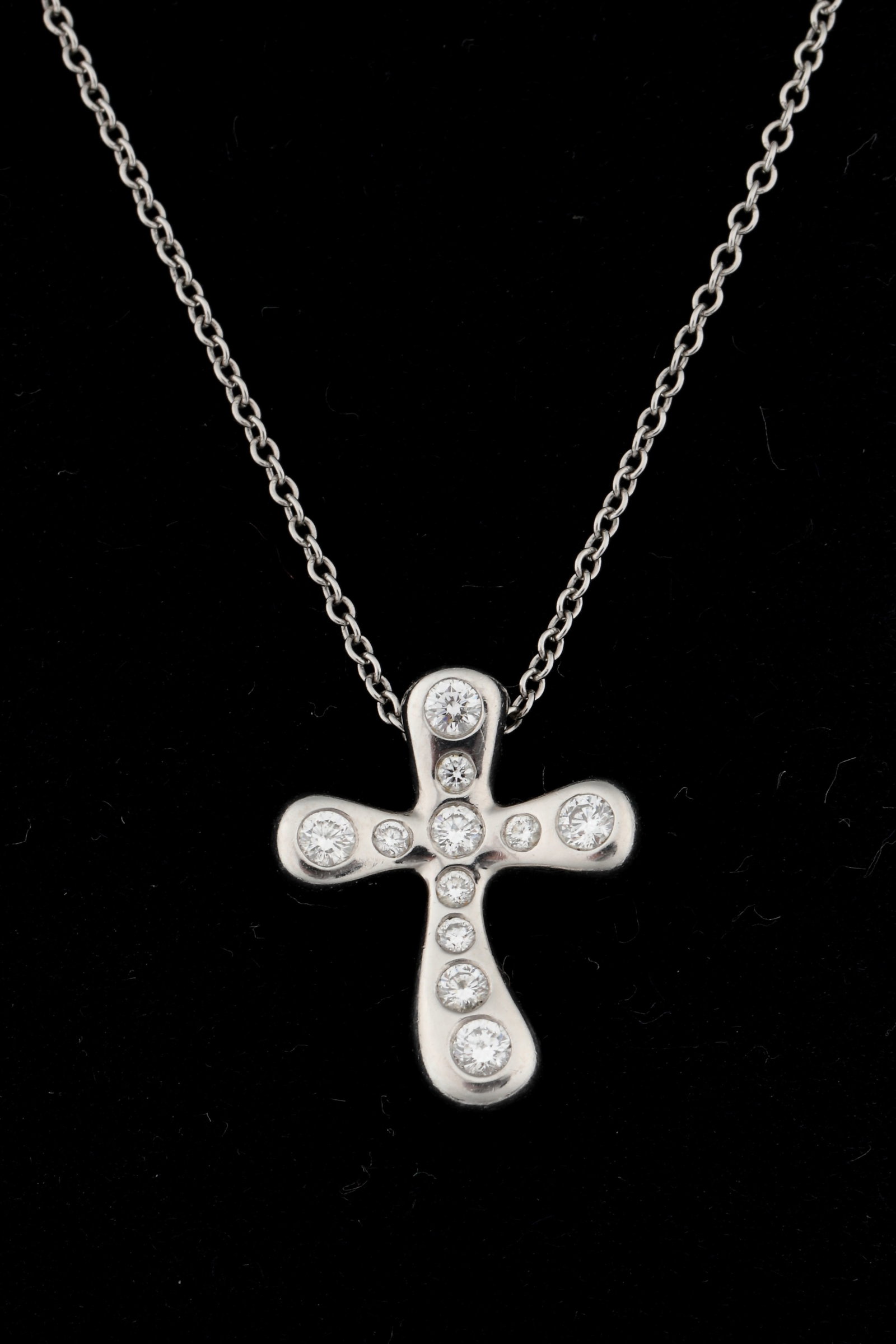 Tiffany & Co., Elsa Peretti: Tiffany & Co., Elsa Peretti Elsa Peretti for Tiffany & Co., 21st Century Delicate platinum cross pendant and chain set with brilliant cut diamonds. Spring washer buckle, stamped: TIFFANY & Co.,