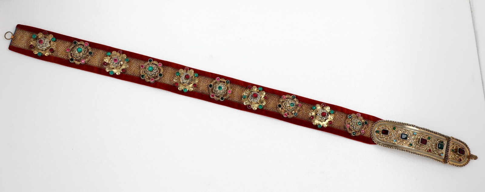 Traditional belt: Traditional belt Transylvania 19th century: Gilt silver clasps with embossed floral decoration and stone embellishment in red, green and blue. Ten bucks with red and green stones on brocade ribbon.