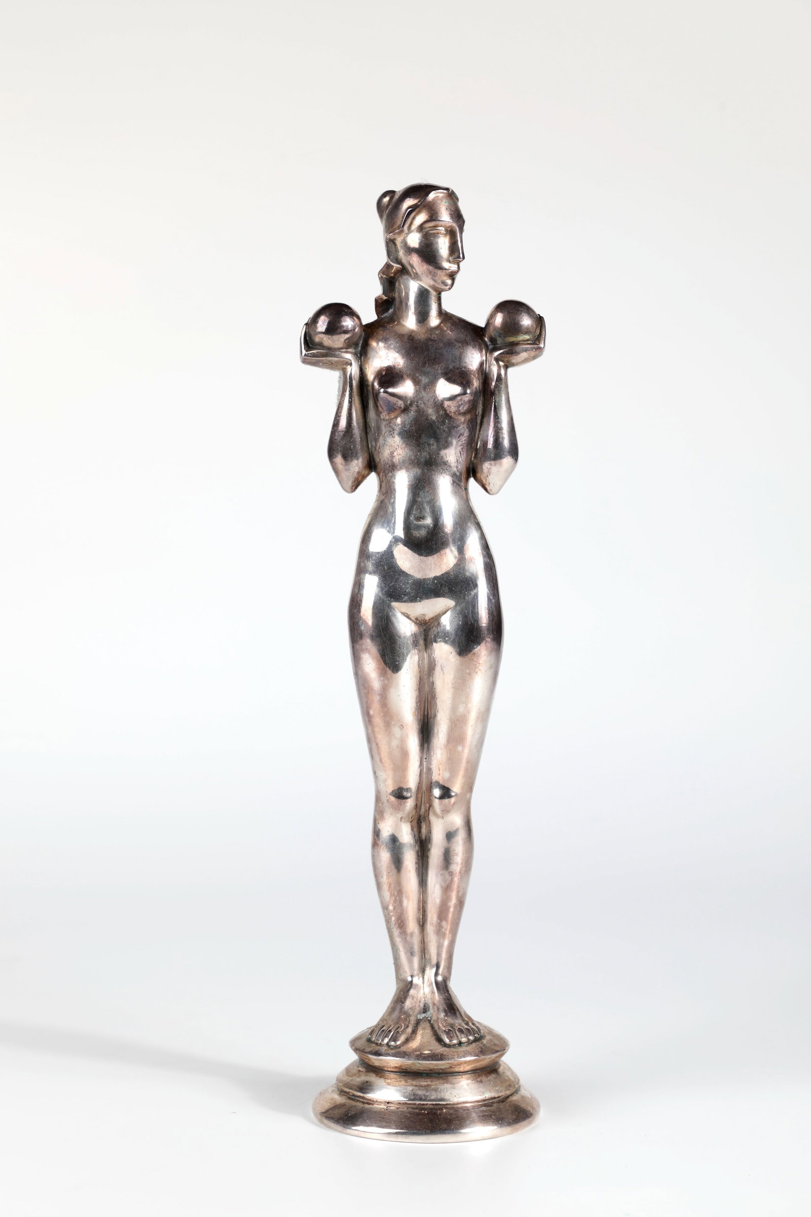 Standing female nude with balls: Standing female nude with balls Hans Laubner, c. 1930 metal, silver-plated. Standing female nude, holding two balls in her hands. On a round, double-stepped disc base. Base signed on the back: H.
