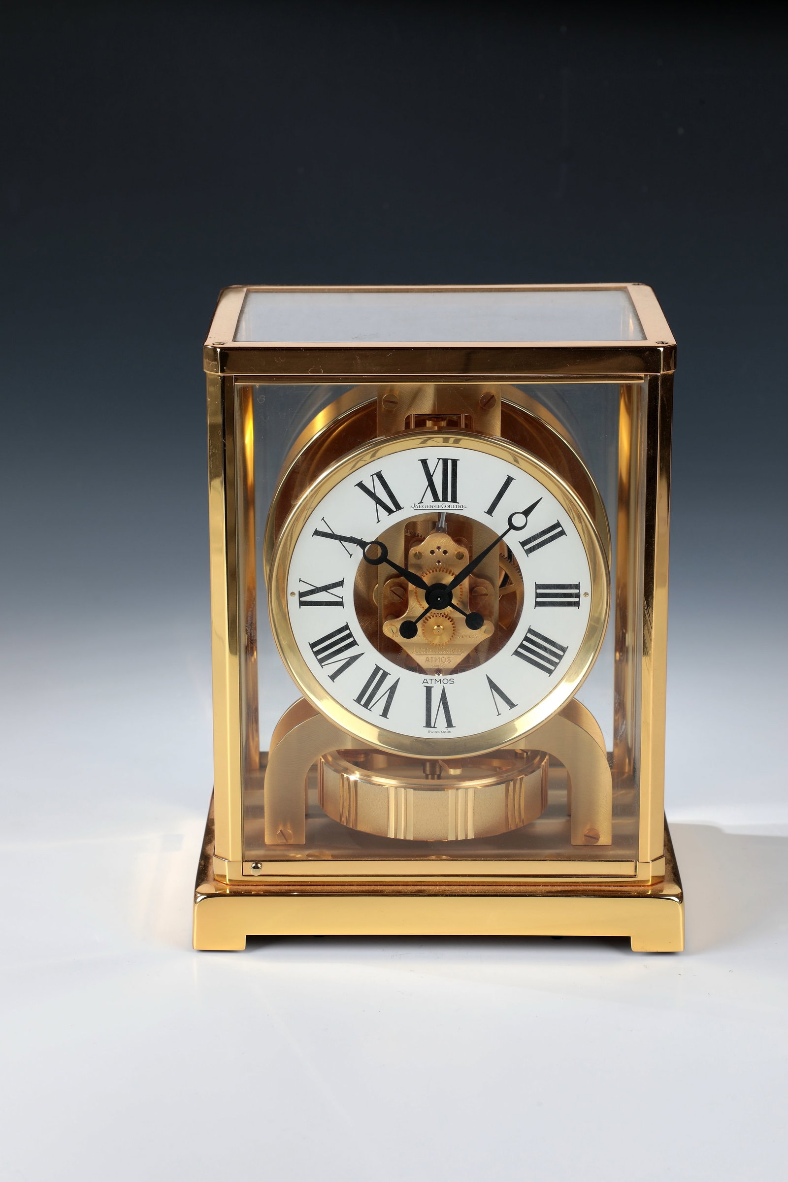 Chest of drawers clock ''ATMOS'': Chest of drawers clock ''ATMOS'' Switzerland, Jaeger LeCoultre Glazed case on all sides with gilded brass edges. White dial ring with Arabic numerals and black Breguet hands. On brass bottom spirit