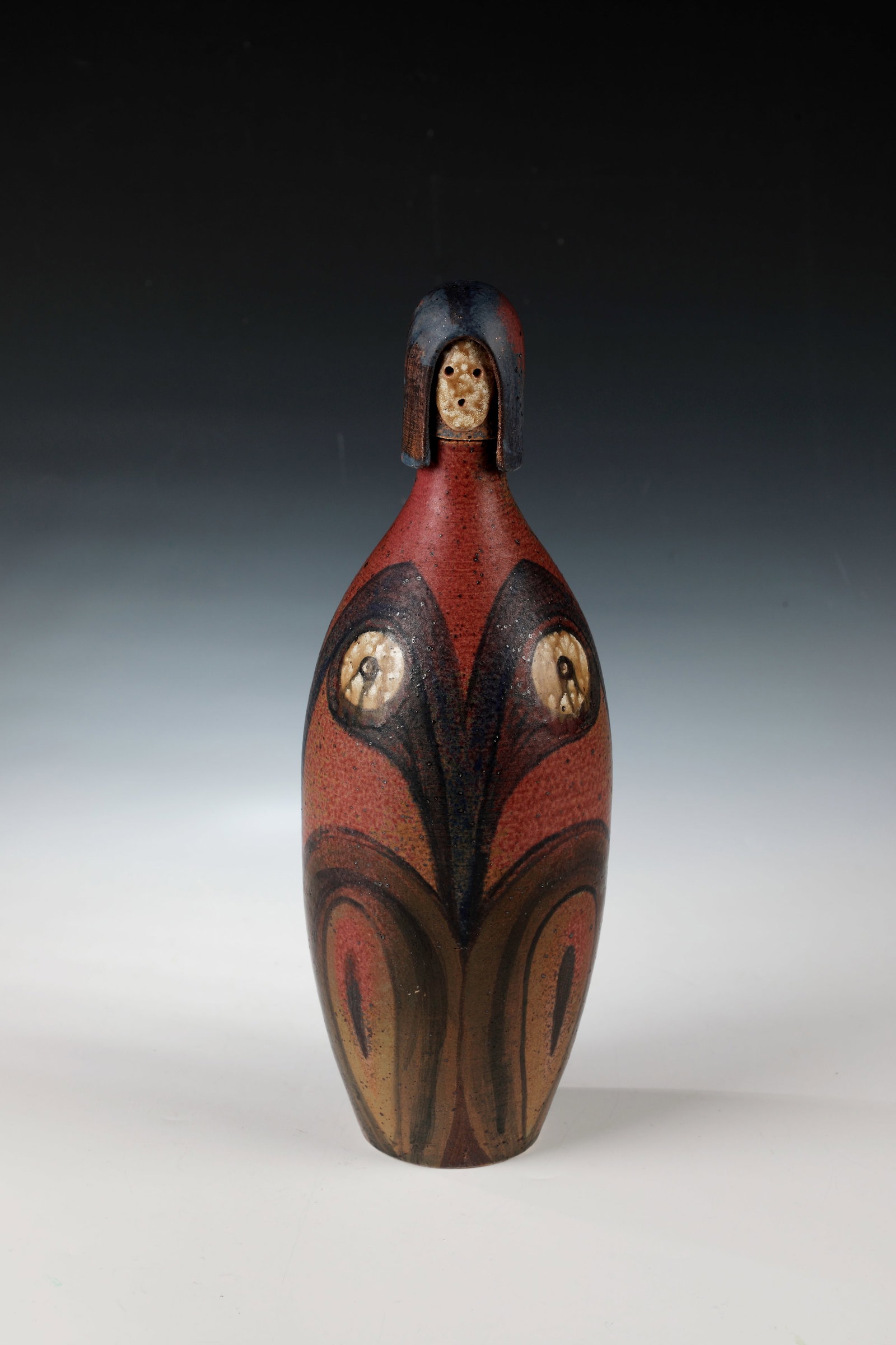 Bottle with stopper: Bottle with stopper Eva Fritz-Lindner, (1933-2017), Majolika Manufaktur Karlsruhe Majolika. Bulbous wall with ornamental decoration in oker, blue and red. Plugs as a stylized woman's head. Floor with