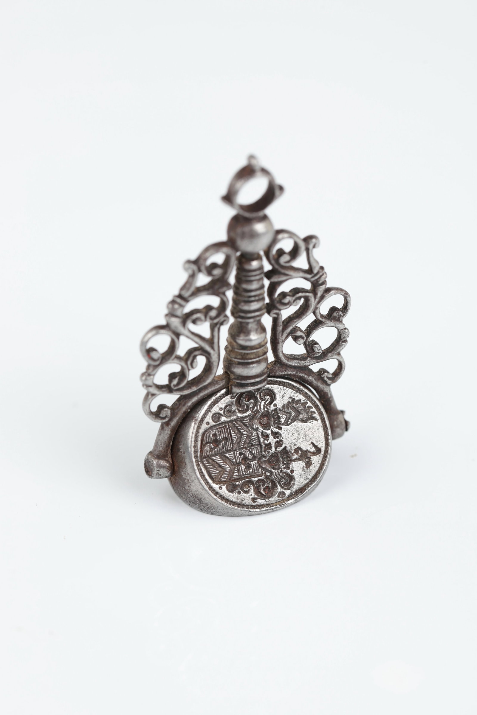 Seal as a pendant: Seal as a pendant German, 18th/19th century Iron. The shaft ornamentally finely worked as tendrils. On two of the three sides recessed coat of arms and crowned cartouche with mirror monogram. H. 4.5