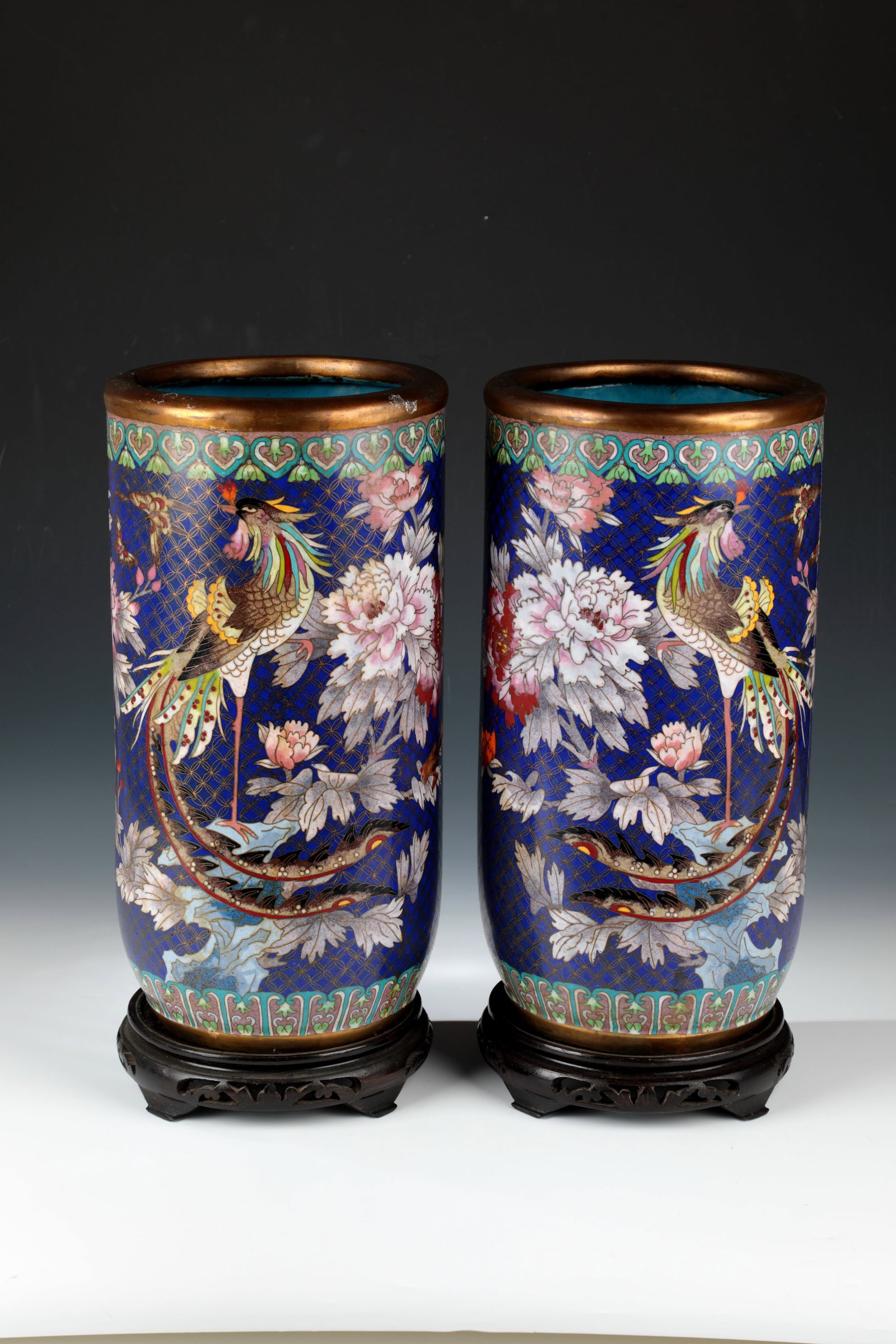 Pair of Cloisonné Floor Vases: Pair of Cloisonné Floor Vases China, circa 1900 A pair of large floor vases in a rounded cylindrical shape, each on a matching wooden base. Floral motifs with butterflies and pheasants. H.