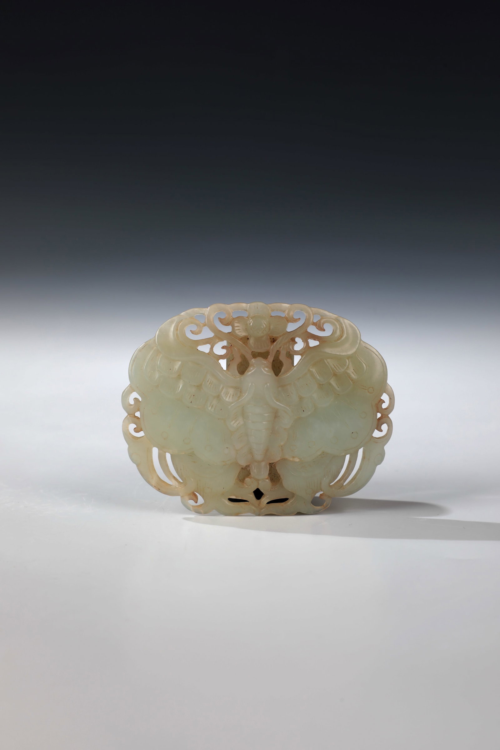 Jade belt buckle: Jade Belt Buckle China, Qing Dynasty Finely crafted belt buckle made of light green celadon jade in the shape of a butterfly with filigree openwork and carved decoration. Back with recess for