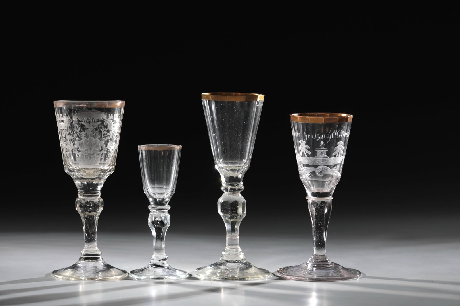 Mixed lot of four trophies: Mixed lot of four goblets Silesia, 18th century. Slightly rising disc foot. Upper with faceted nodus. The multi-faceted cuppa with all-round, area-filling matt and bleached cut decoration: eagle with